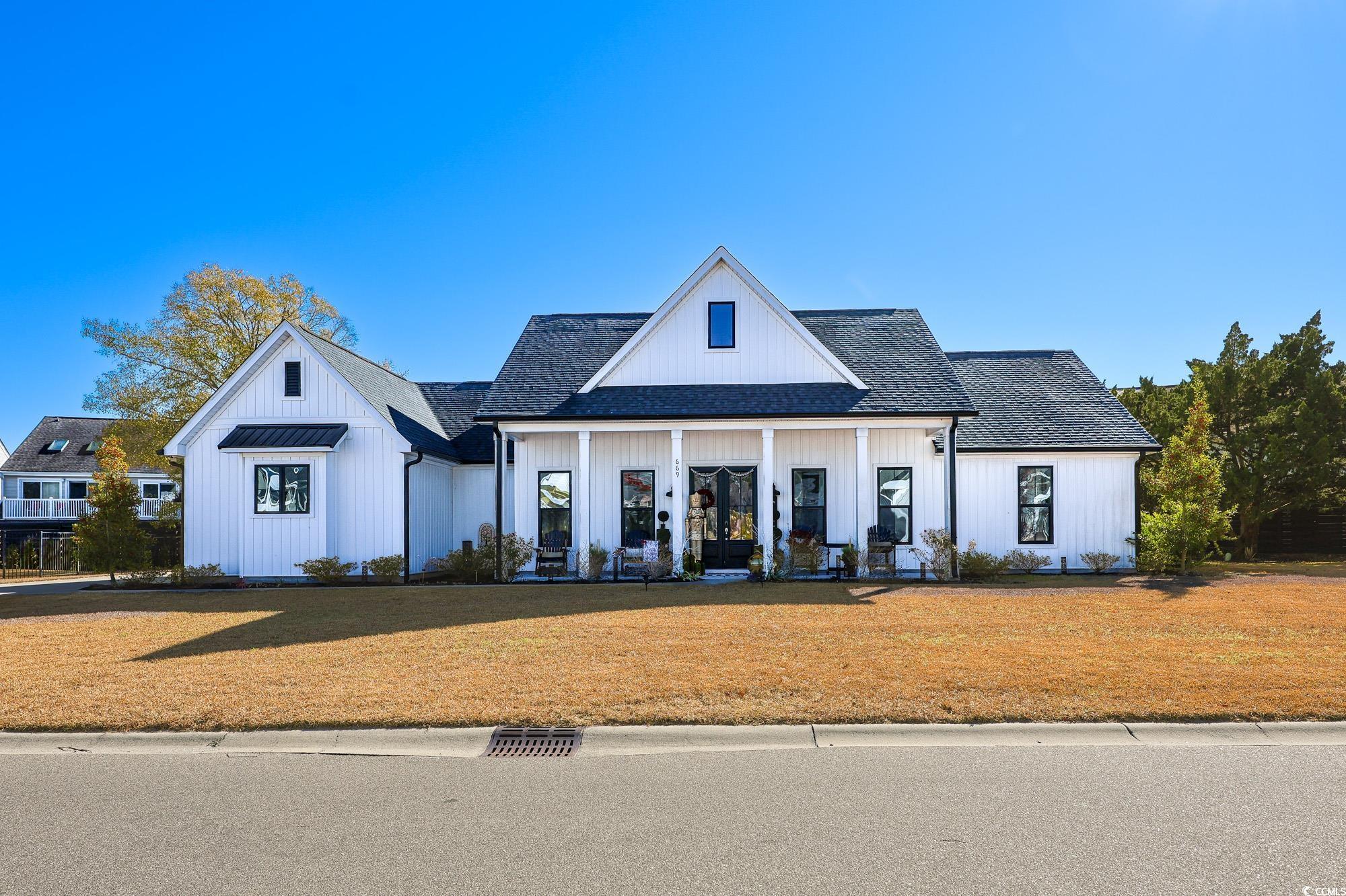 Image 1: Modern farmhouse style home with a porch, a shingl Image 1: Modern farmhouse style home with a porch, a shingl