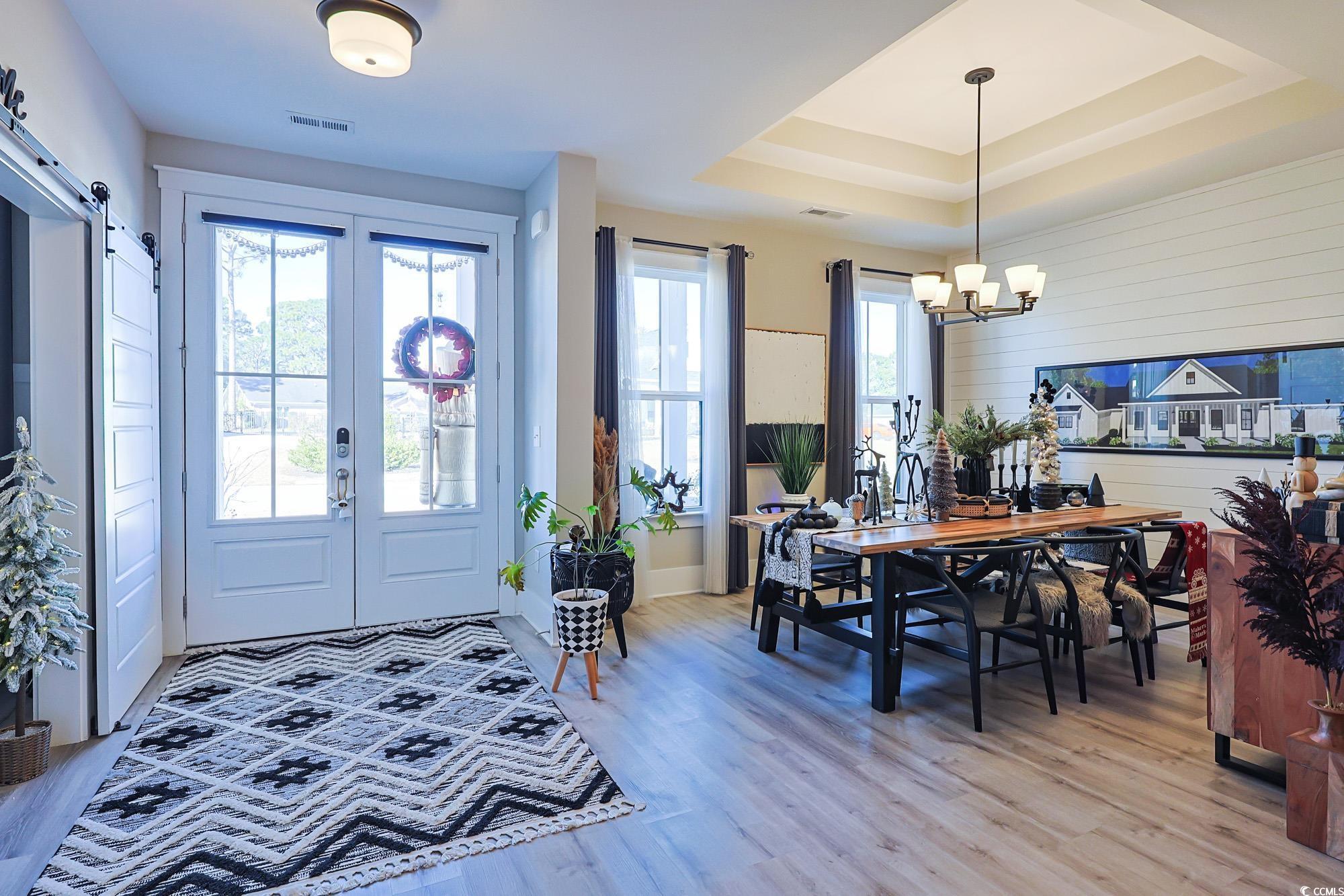 Image 2: Foyer featuring a barn door, light wood-style floo Image 2: Foyer featuring a barn door, light wood-style floo