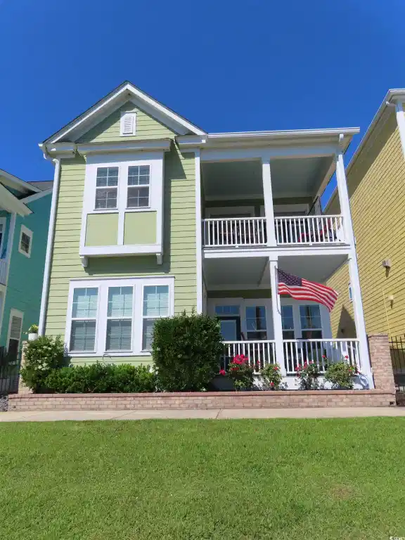 Image 1: View of front facade with a front lawn and a porch