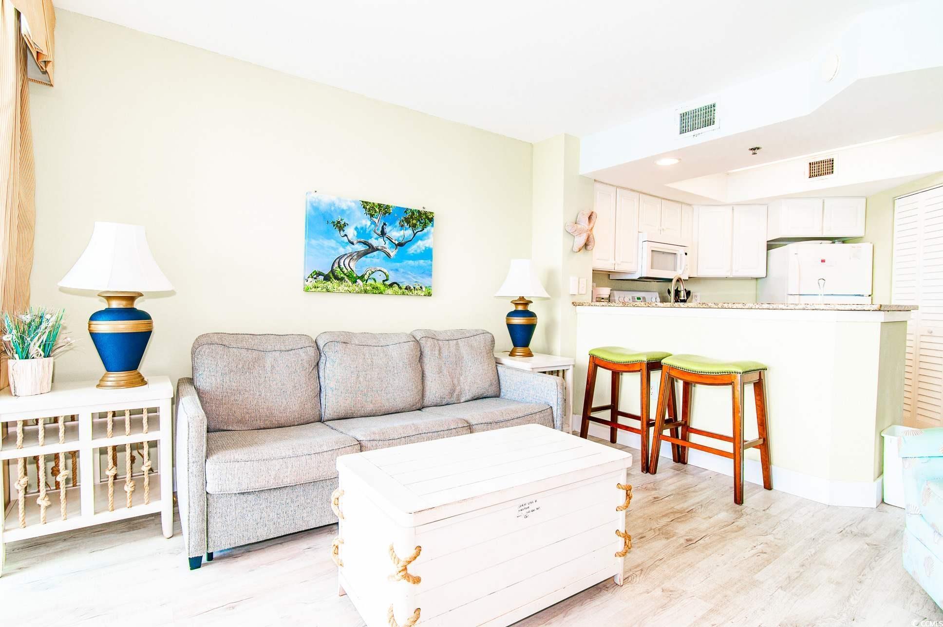 Image 3: Living area featuring light wood finished floors a