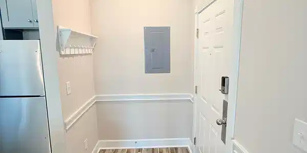 Image 2: Doorway to outside featuring crown molding, wood f Image 2: Doorway to outside featuring crown molding, wood f
