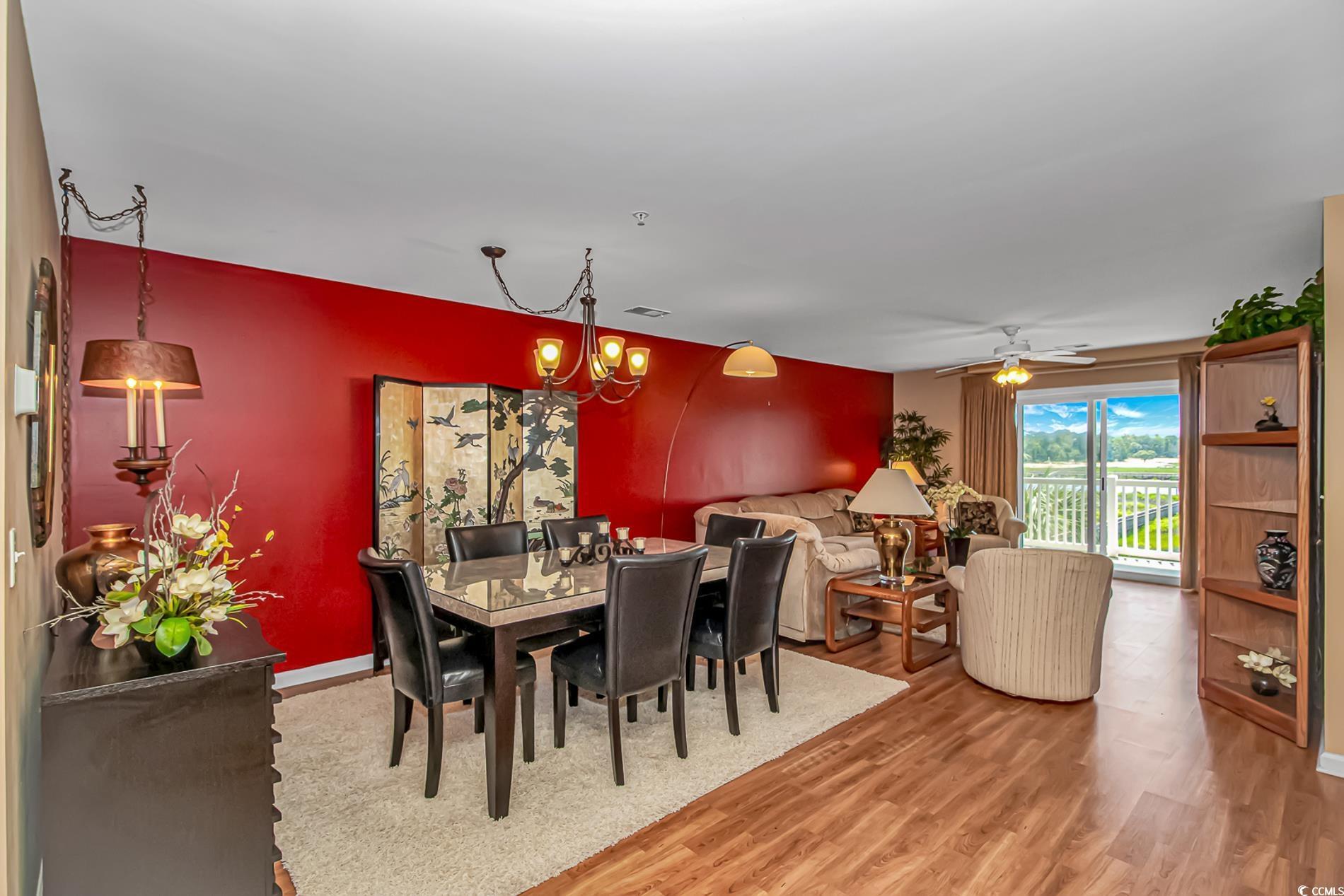 Image 3: Dining area with light wood-style floors, a chande Image 3: Dining area with light wood-style floors, a chande