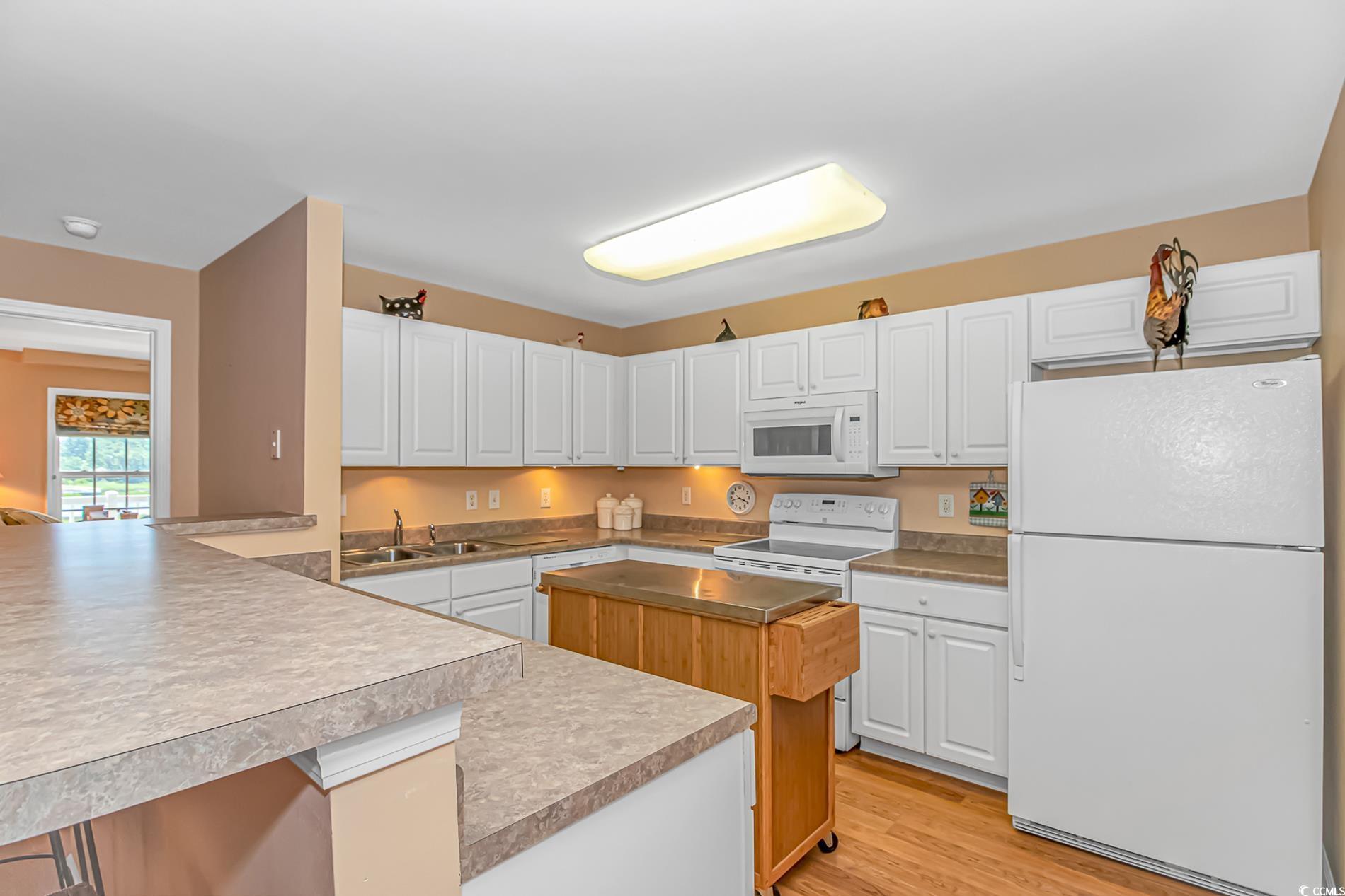 Image 4: Kitchen featuring white appliances, white cabinets Image 4: Kitchen featuring white appliances, white cabinets