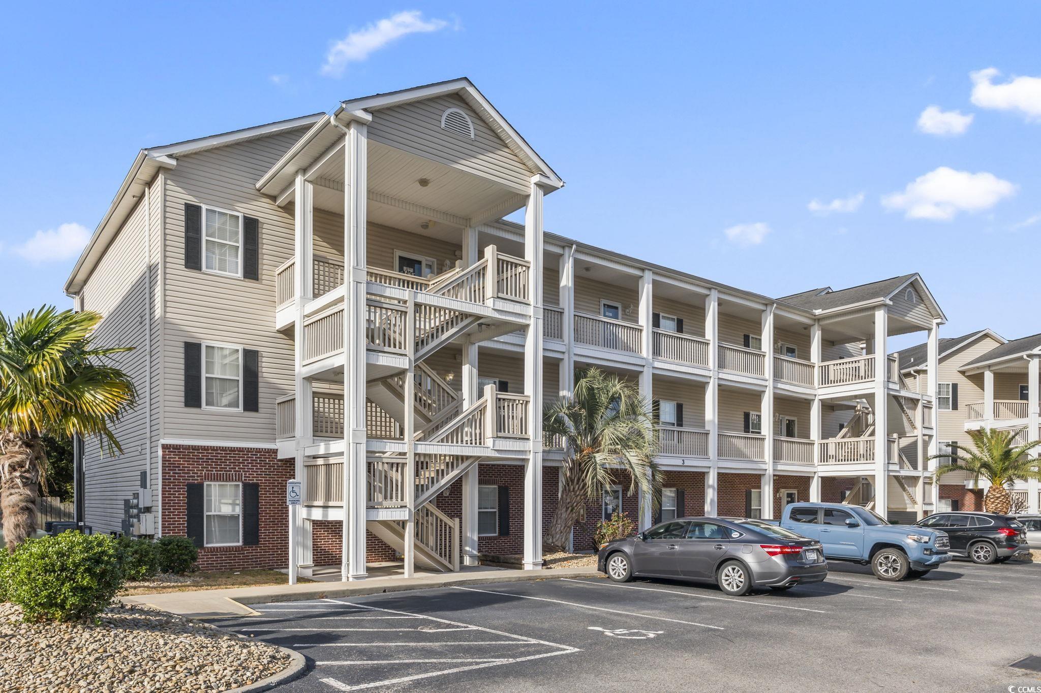 Image 1: View of apartment building / complex with uncovere