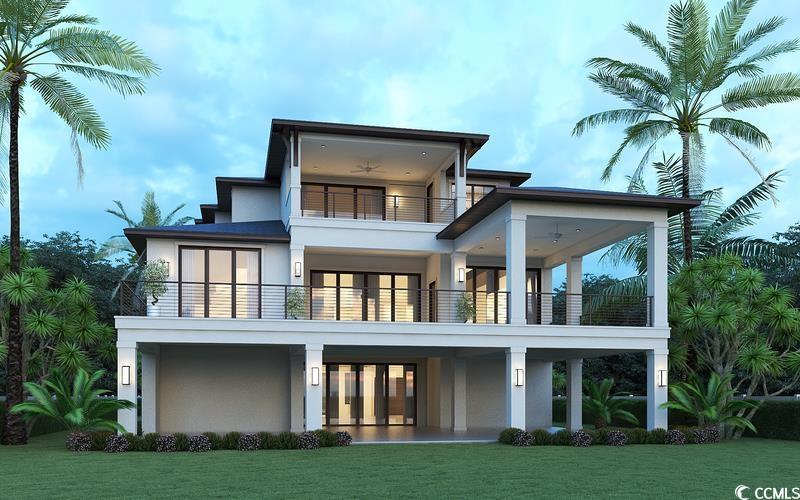 Image 3: Rear view of property with a lawn, a balcony, and