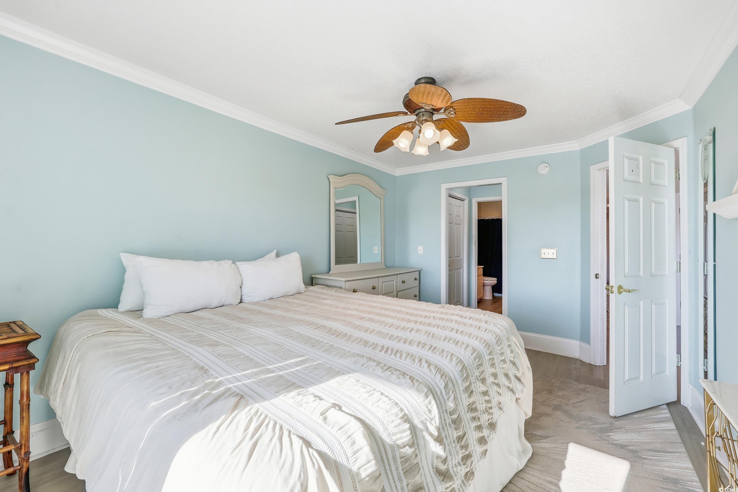 Image 4: Bedroom featuring crown molding, ceiling fan, and