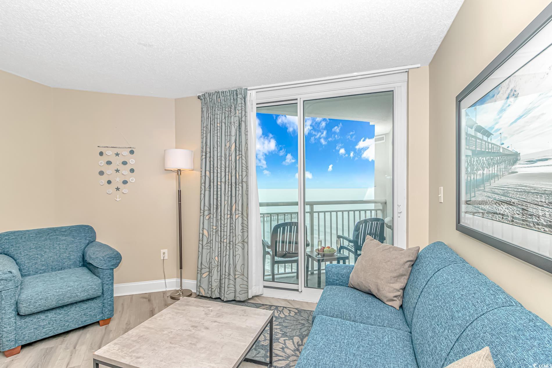 Image 4: Living room with a water view, wood finished floor