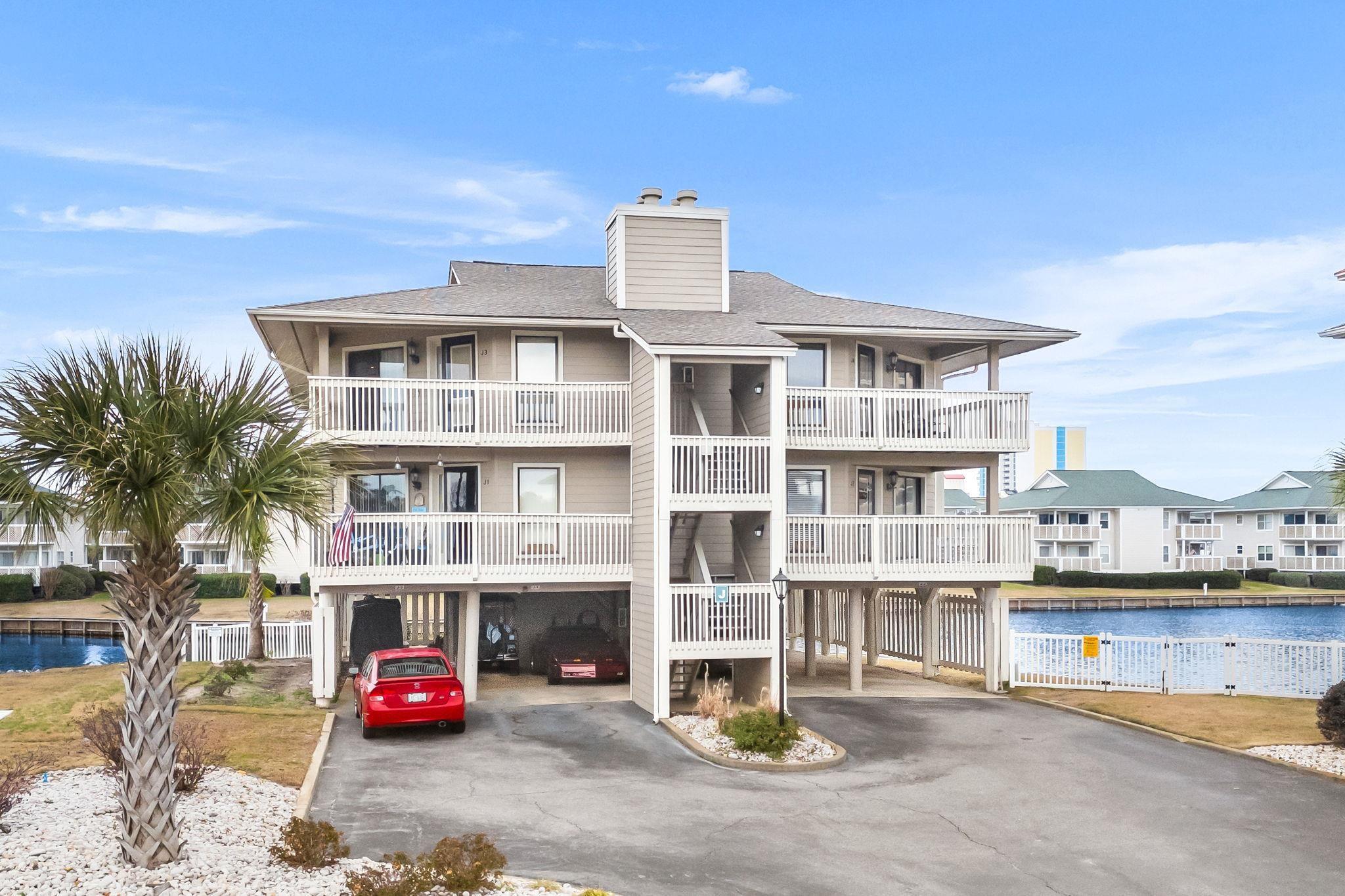 Image 1: View of apartment building / complex with a carpor Image 1: View of apartment building / complex with a carpor