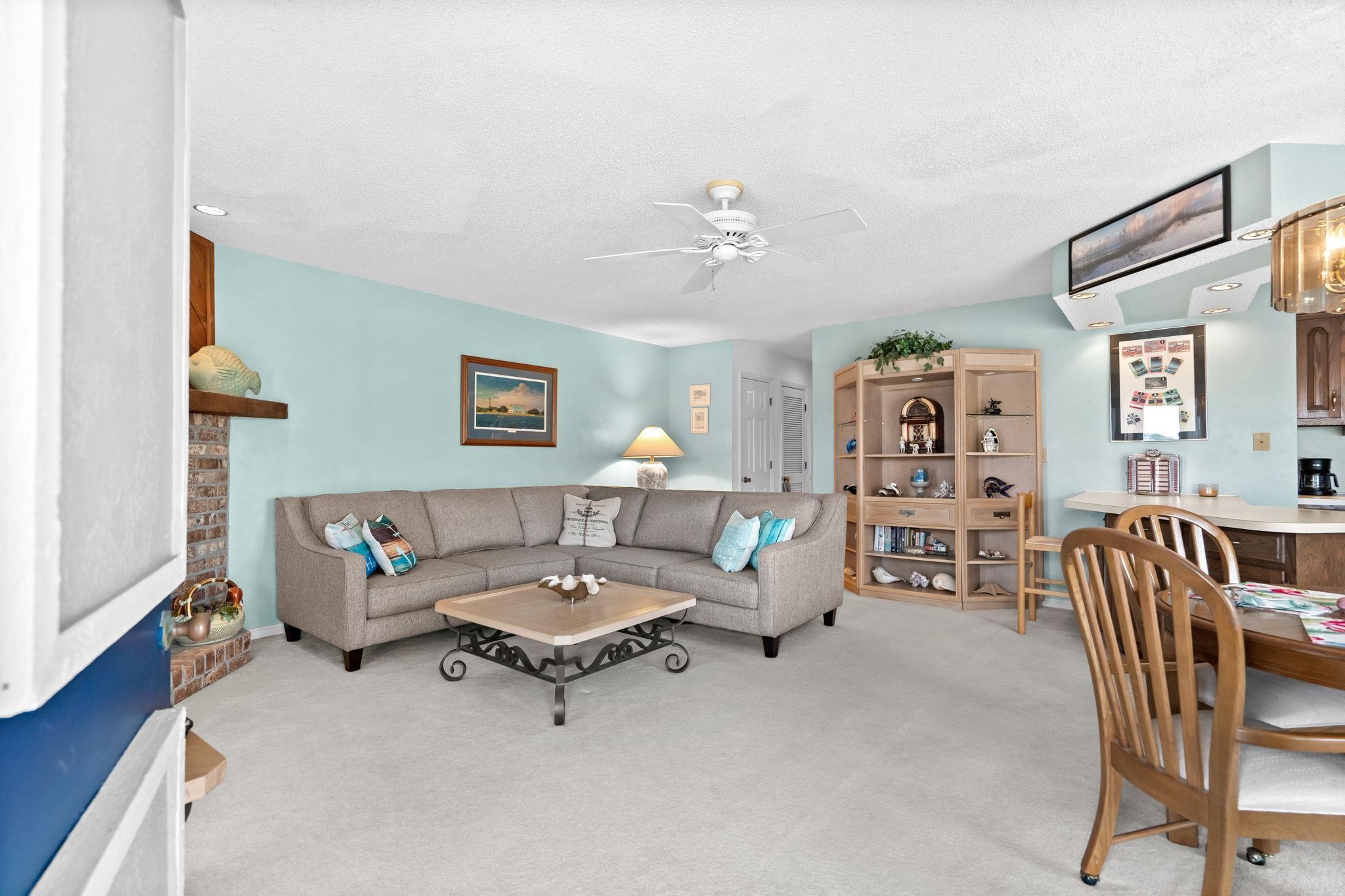 Image 4: Living room featuring light carpet, ceiling fan, a Image 4: Living room featuring light carpet, ceiling fan, a