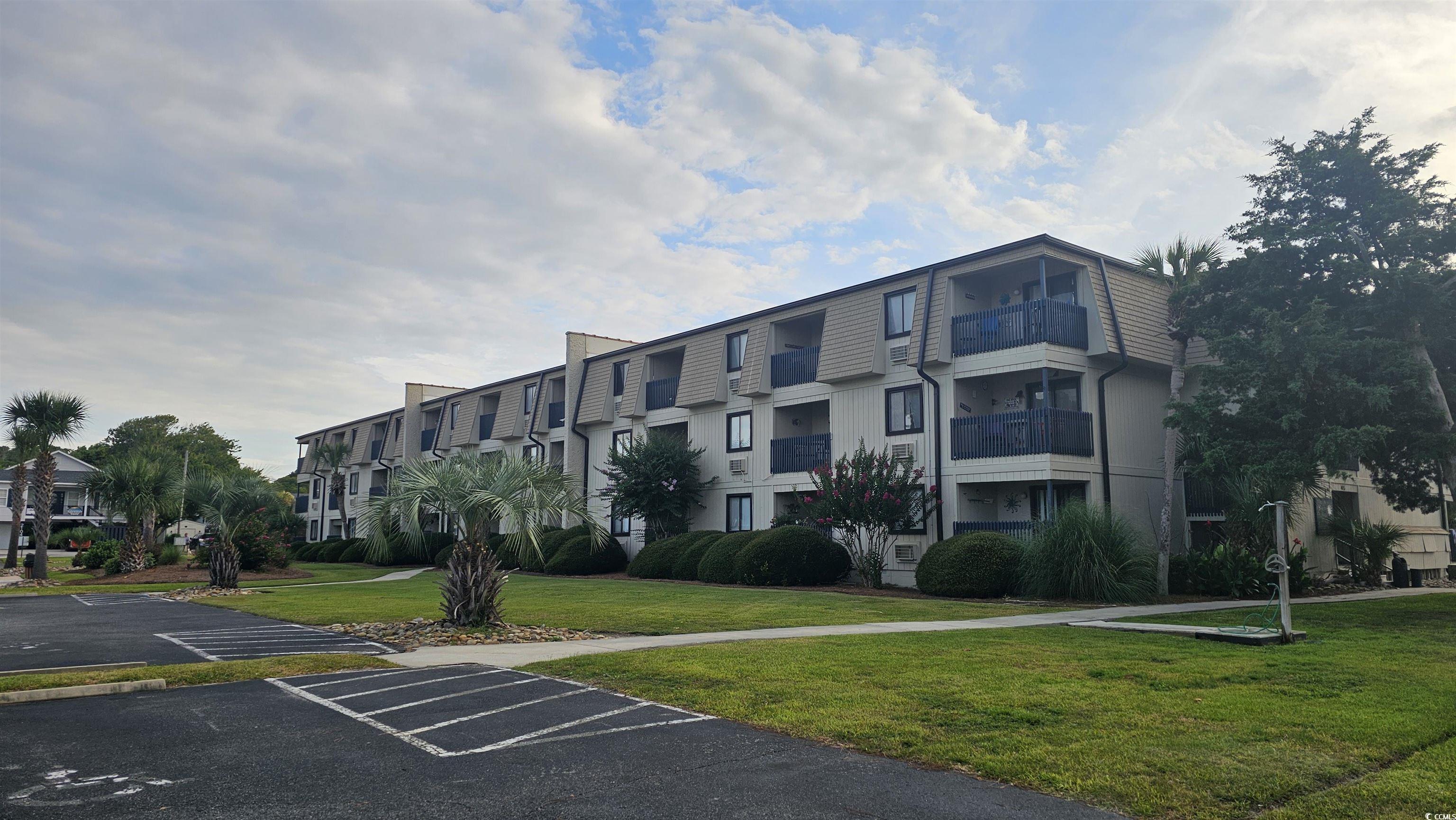Image 1: View of property with uncovered parking and a resi Image 1: View of property with uncovered parking and a resi