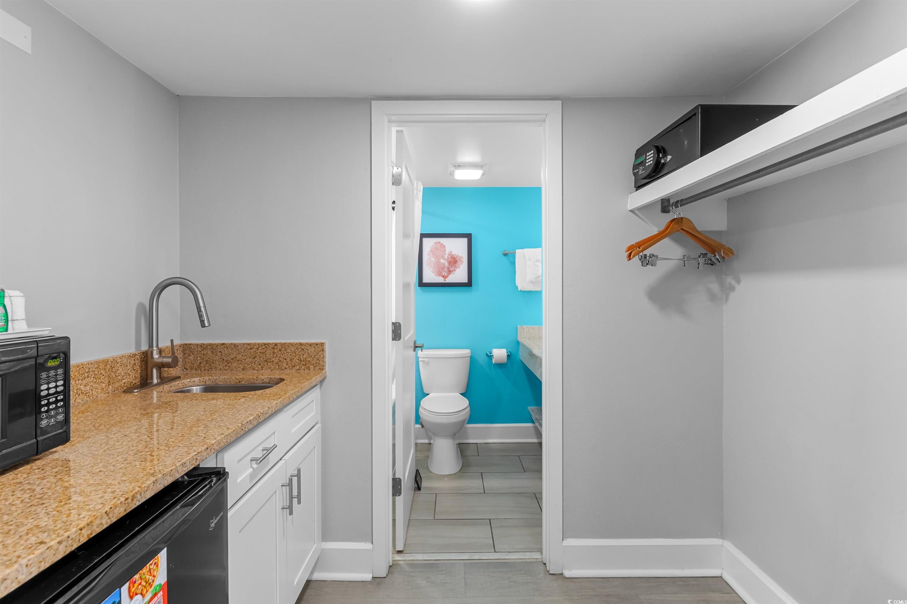 Image 3: Bathroom featuring baseboards, vanity, and toilet