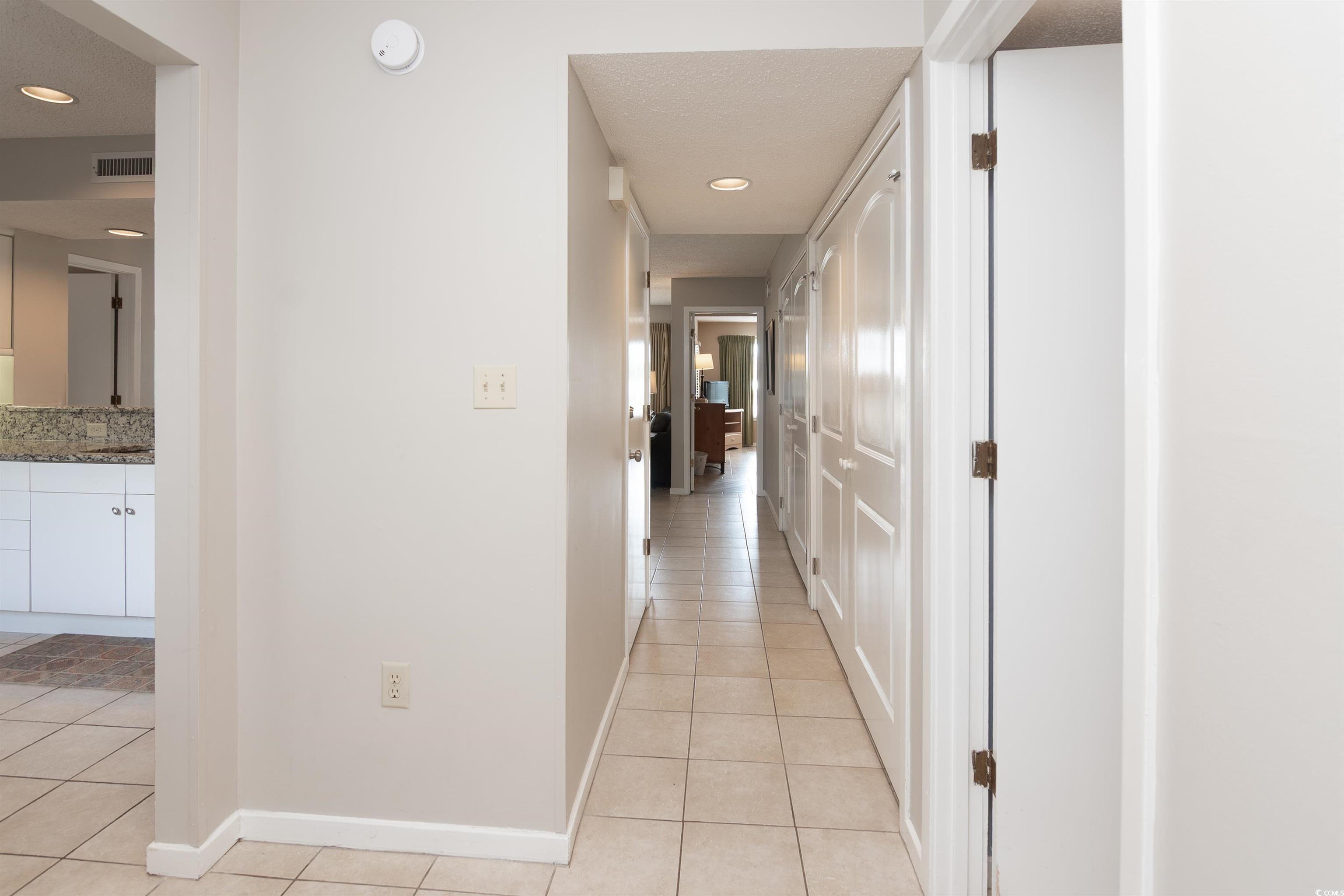 Image 3: Hallway with light tile patterned floors and reces