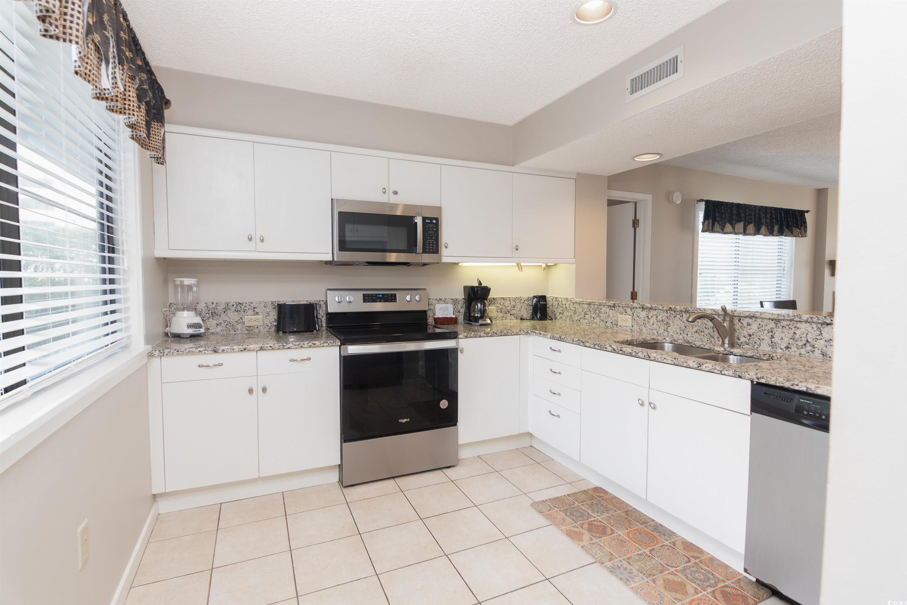 Image 4: Kitchen featuring stainless steel appliances, whit