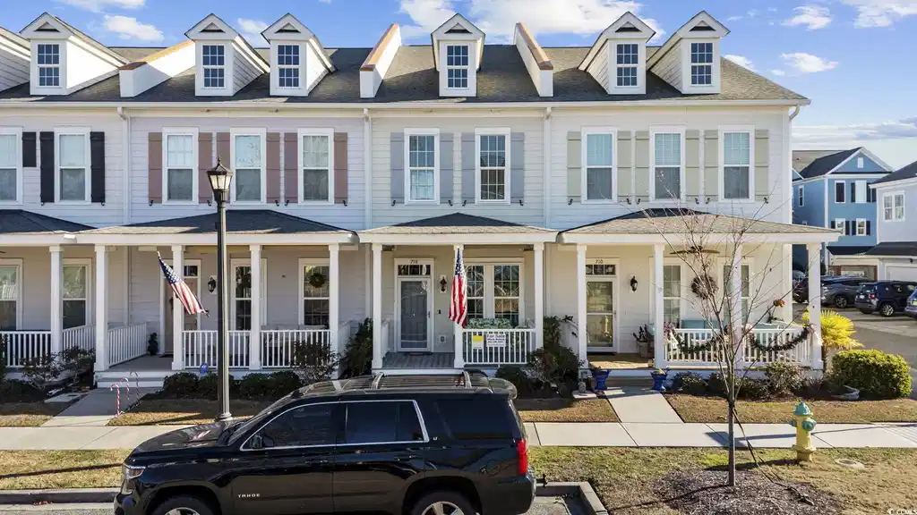 Image 1: View of front of house featuring a porch and a shi Image 1: View of front of house featuring a porch and a shi