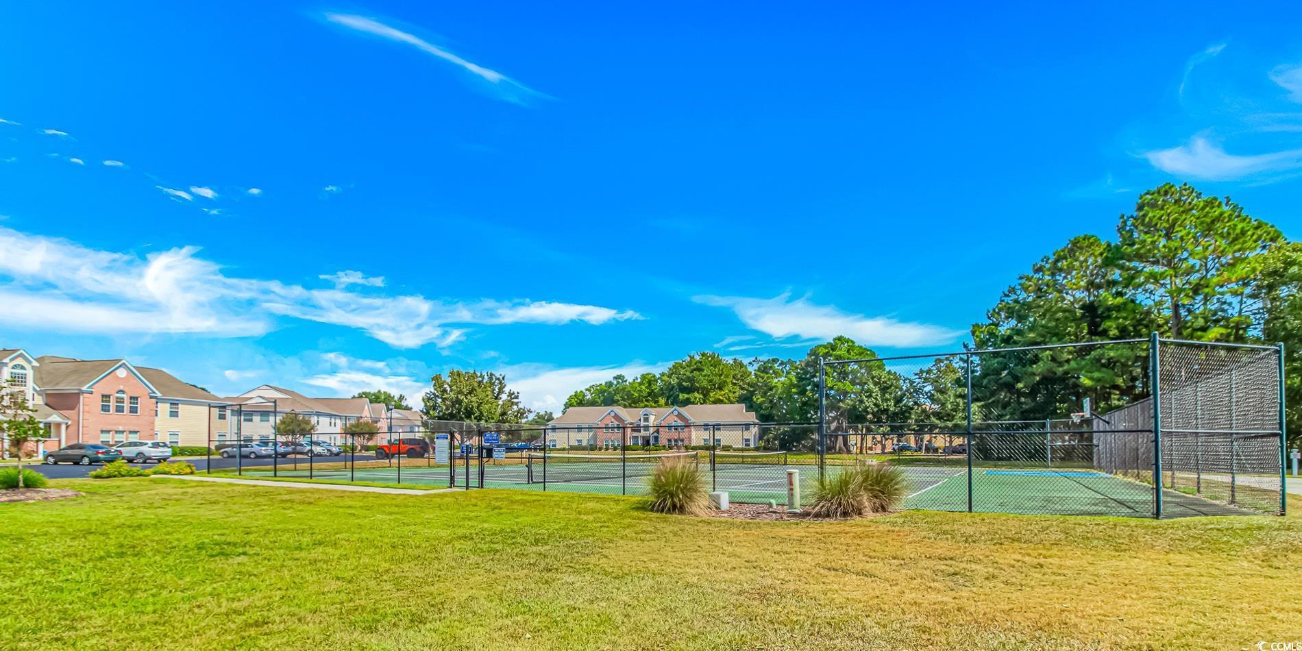 Image 4: View of tennis court with a residential view Image 4: View of tennis court with a residential view