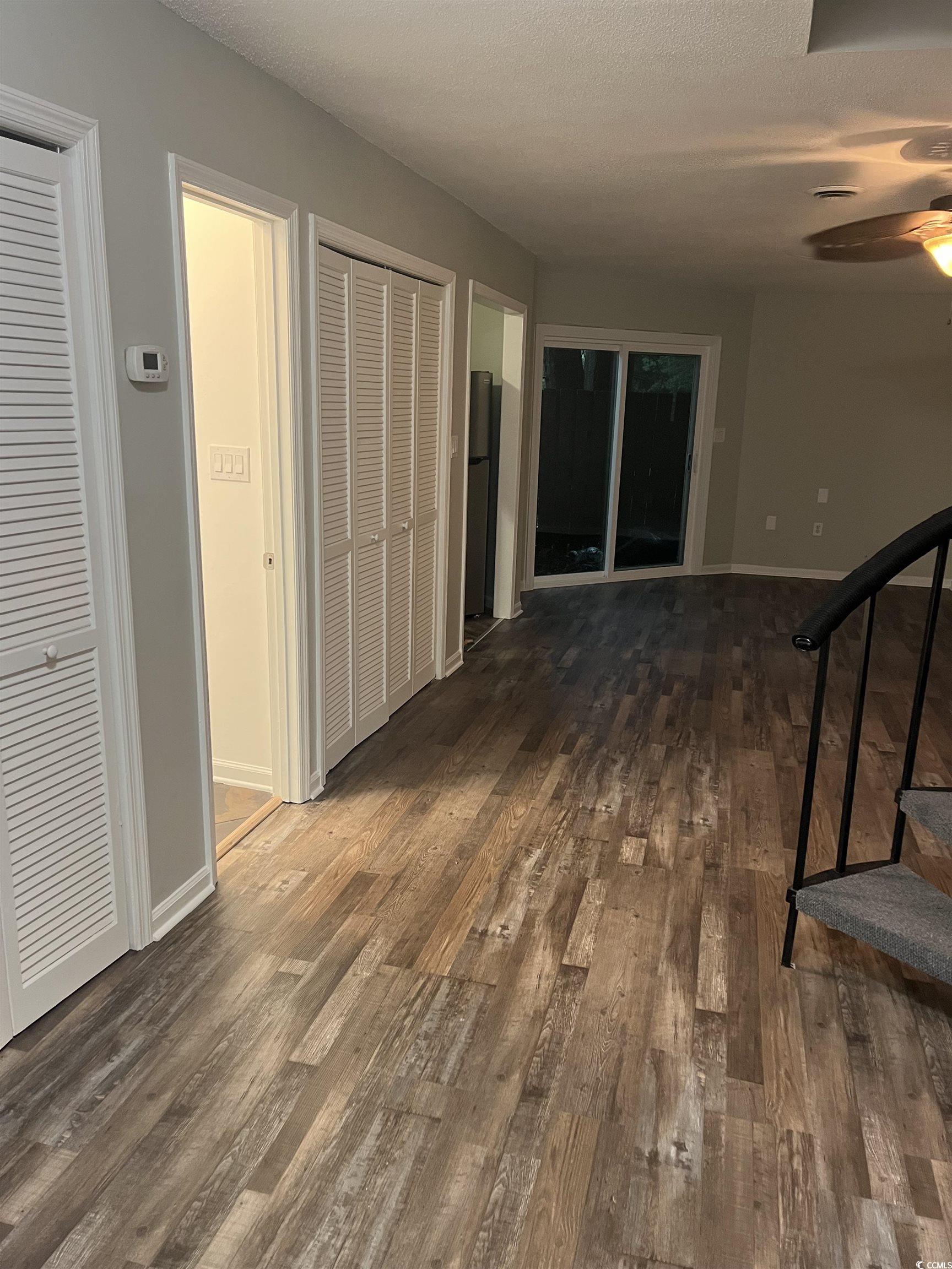 Image 4: Hall with dark wood-type flooring, a textured ceil Image 4: Hall with dark wood-type flooring, a textured ceil
