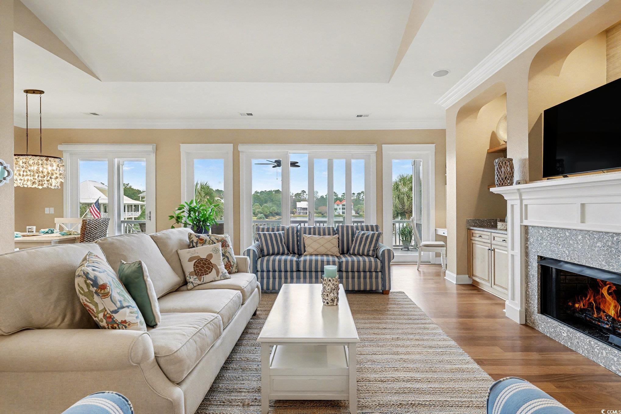 Image 2: Living area featuring light wood-style flooring, a