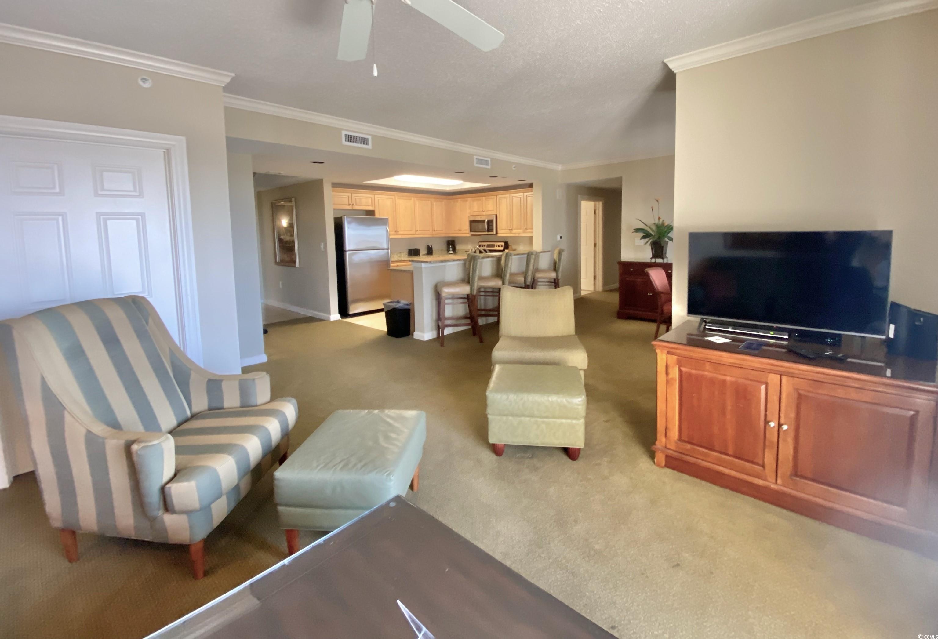 Image 2: Carpeted living room with a textured ceiling, ceil Image 2: Carpeted living room with a textured ceiling, ceil