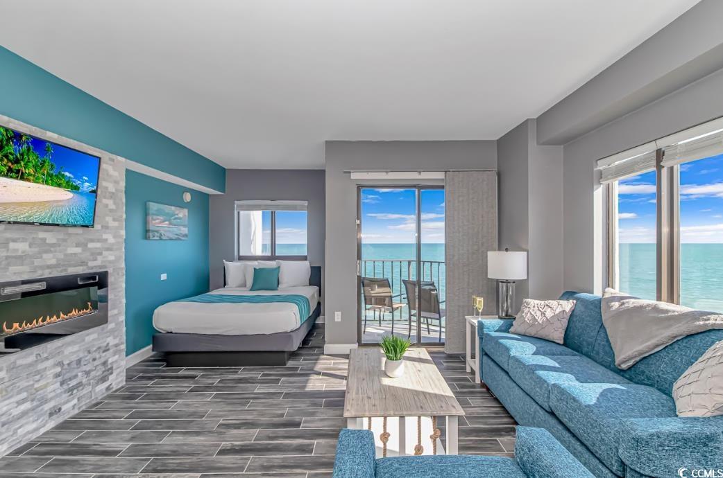 Image 3: Bedroom featuring a water view, a glass covered fi Image 3: Bedroom featuring a water view, a glass covered fi