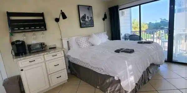 Image 2: Bedroom with light tile patterned floors and acces Image 2: Bedroom with light tile patterned floors and acces