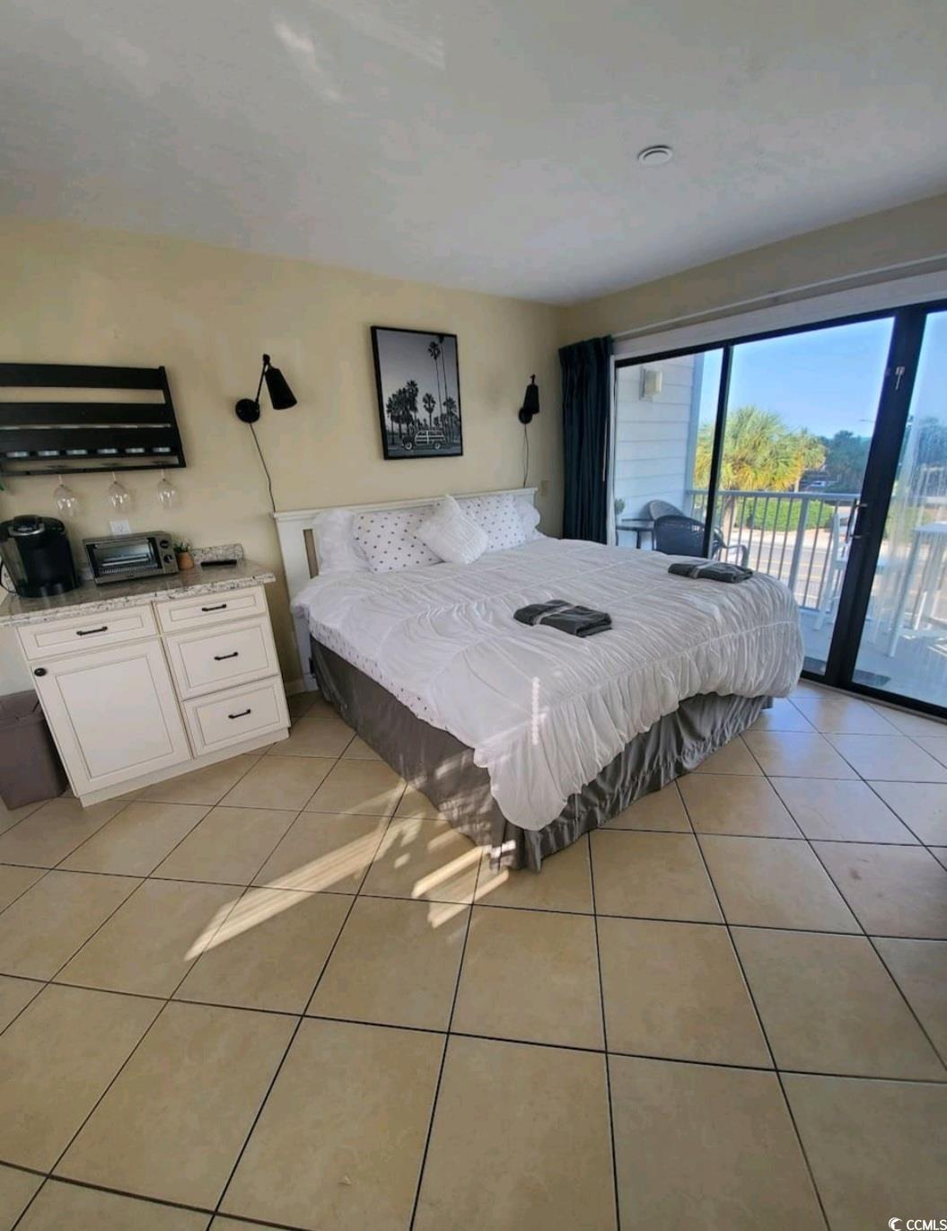 Image 4: Bedroom with light tile patterned floors and acces Image 4: Bedroom with light tile patterned floors and acces
