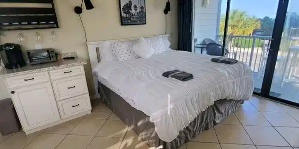 Image 4: Bedroom with light tile patterned floors and acces Image 4: Bedroom with light tile patterned floors and acces