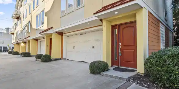 Image 2: Property entrance with stucco siding, an attached Image 2: Property entrance with stucco siding, an attached
