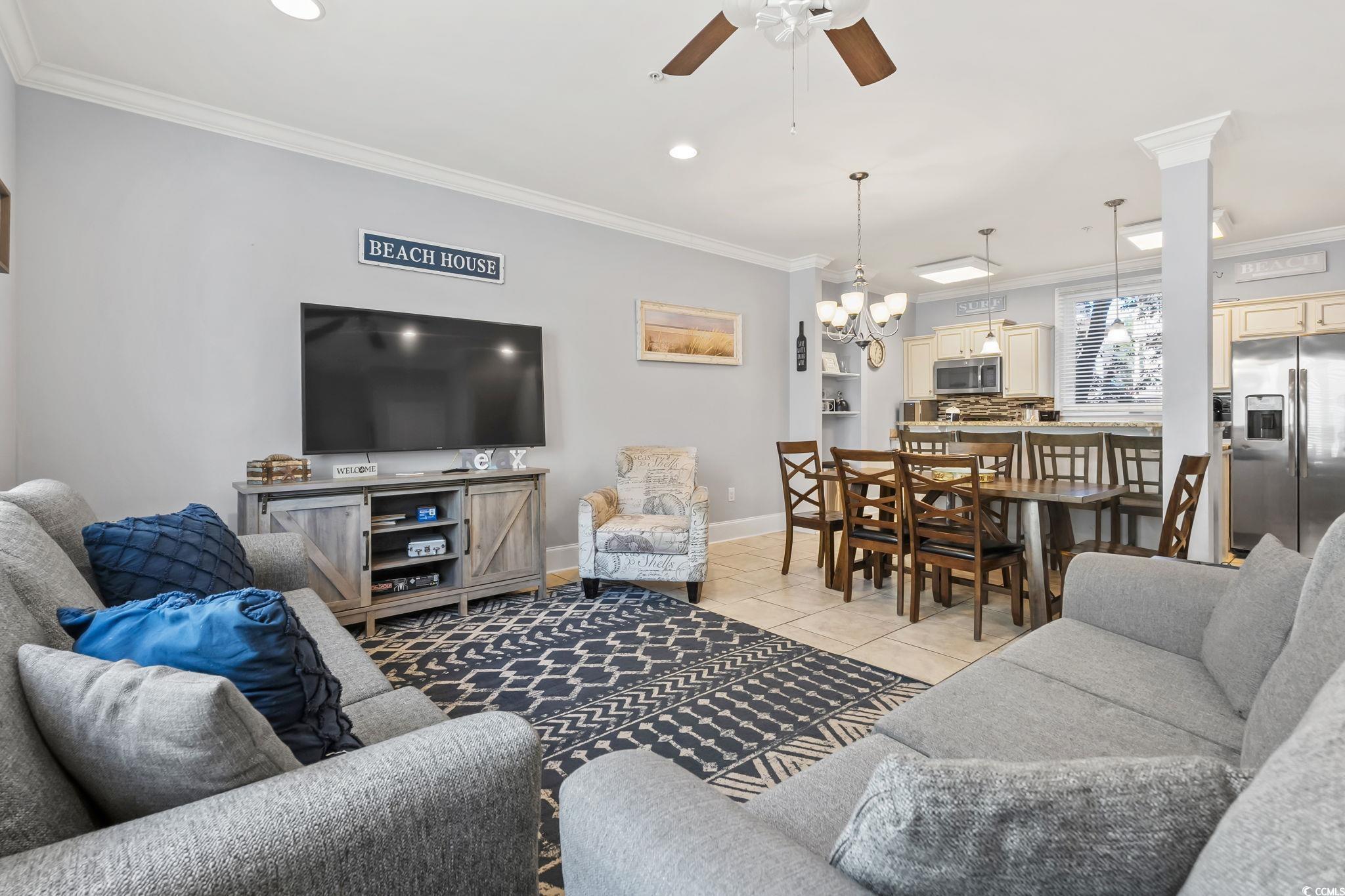 Image 3: Living area with ceiling fan, ornamental molding,