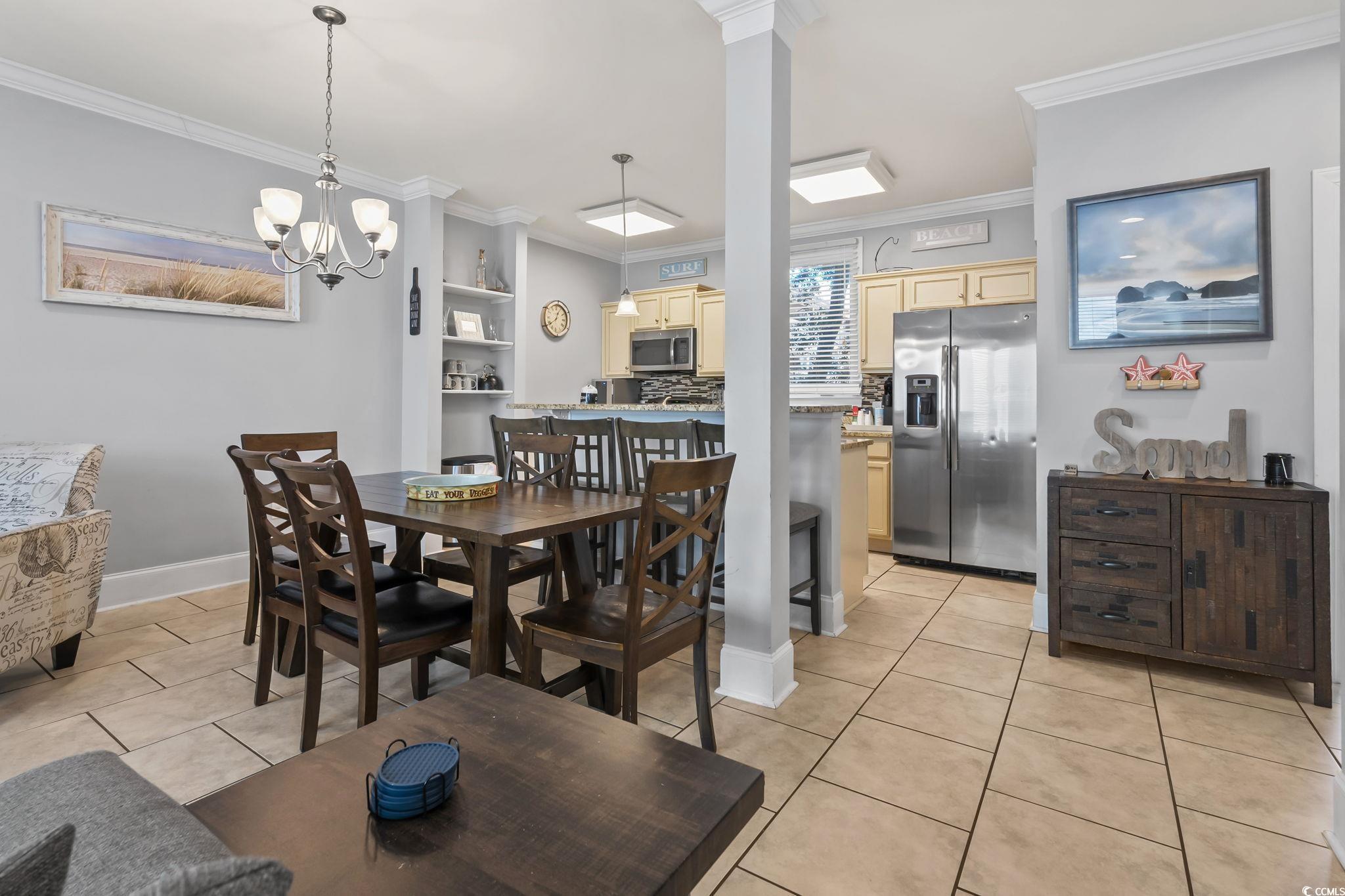 Image 4: Dining area featuring light tile patterned floors,