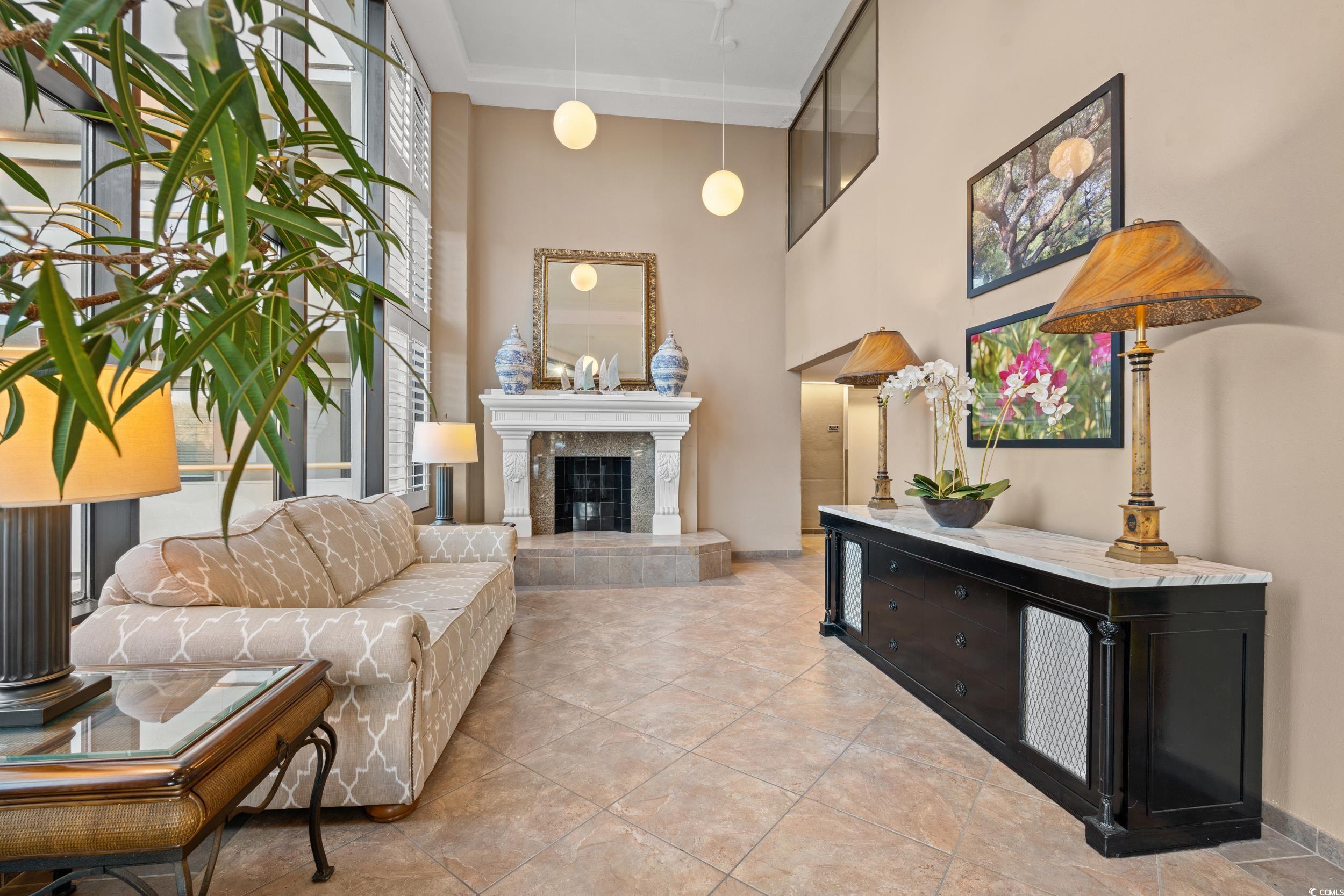 Image 3: Living room with a premium fireplace and a towerin