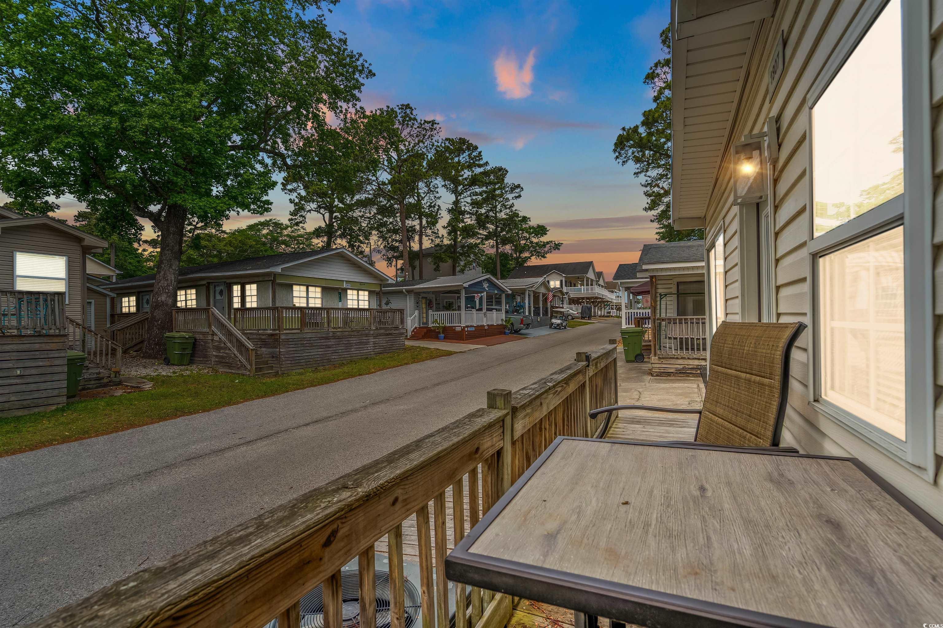 Image 2: Balcony at dusk with a residential view and stairw Image 2: Balcony at dusk with a residential view and stairw