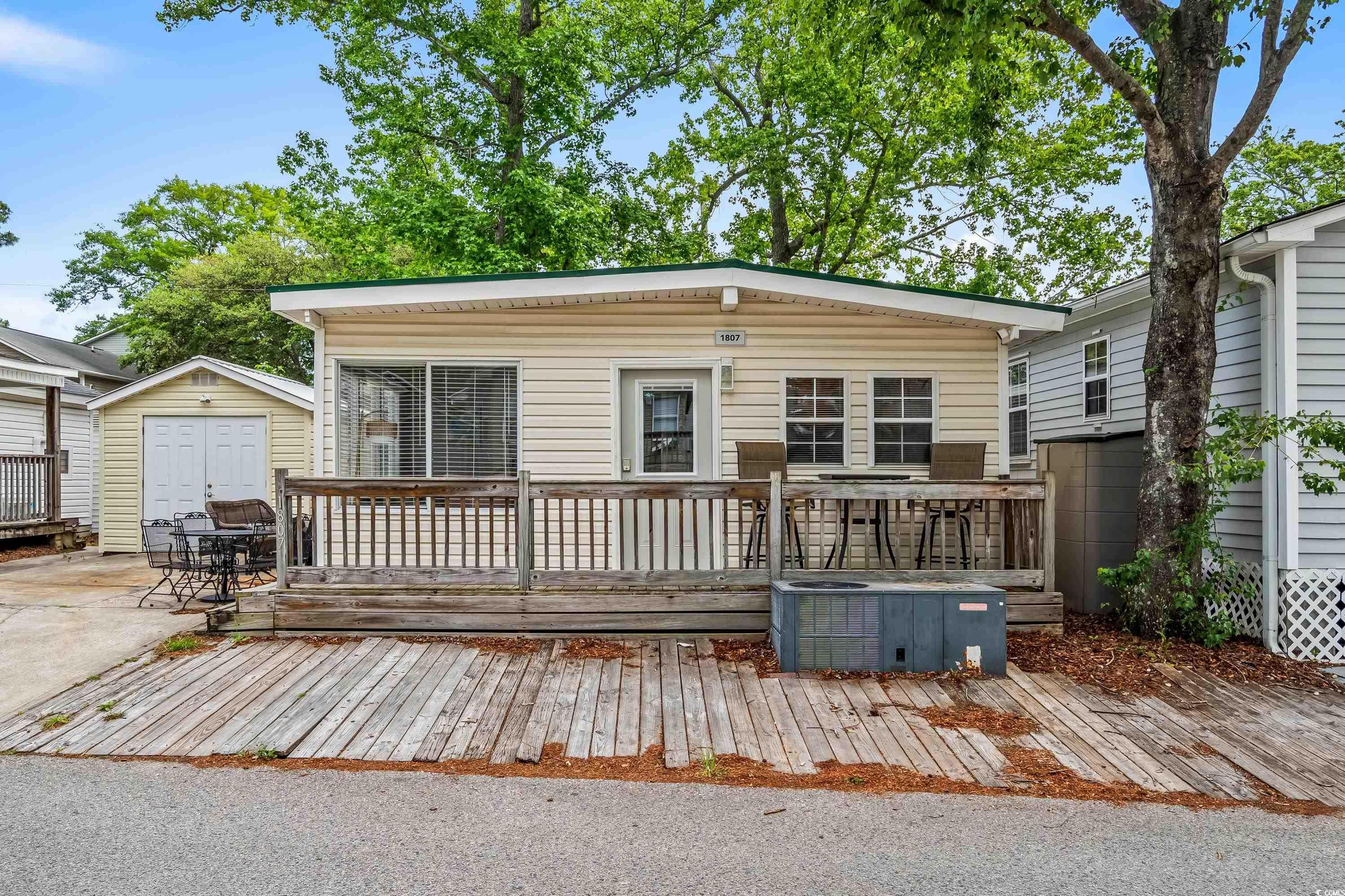 Image 4: View of front of house featuring a deck, a shed, a Image 4: View of front of house featuring a deck, a shed, a