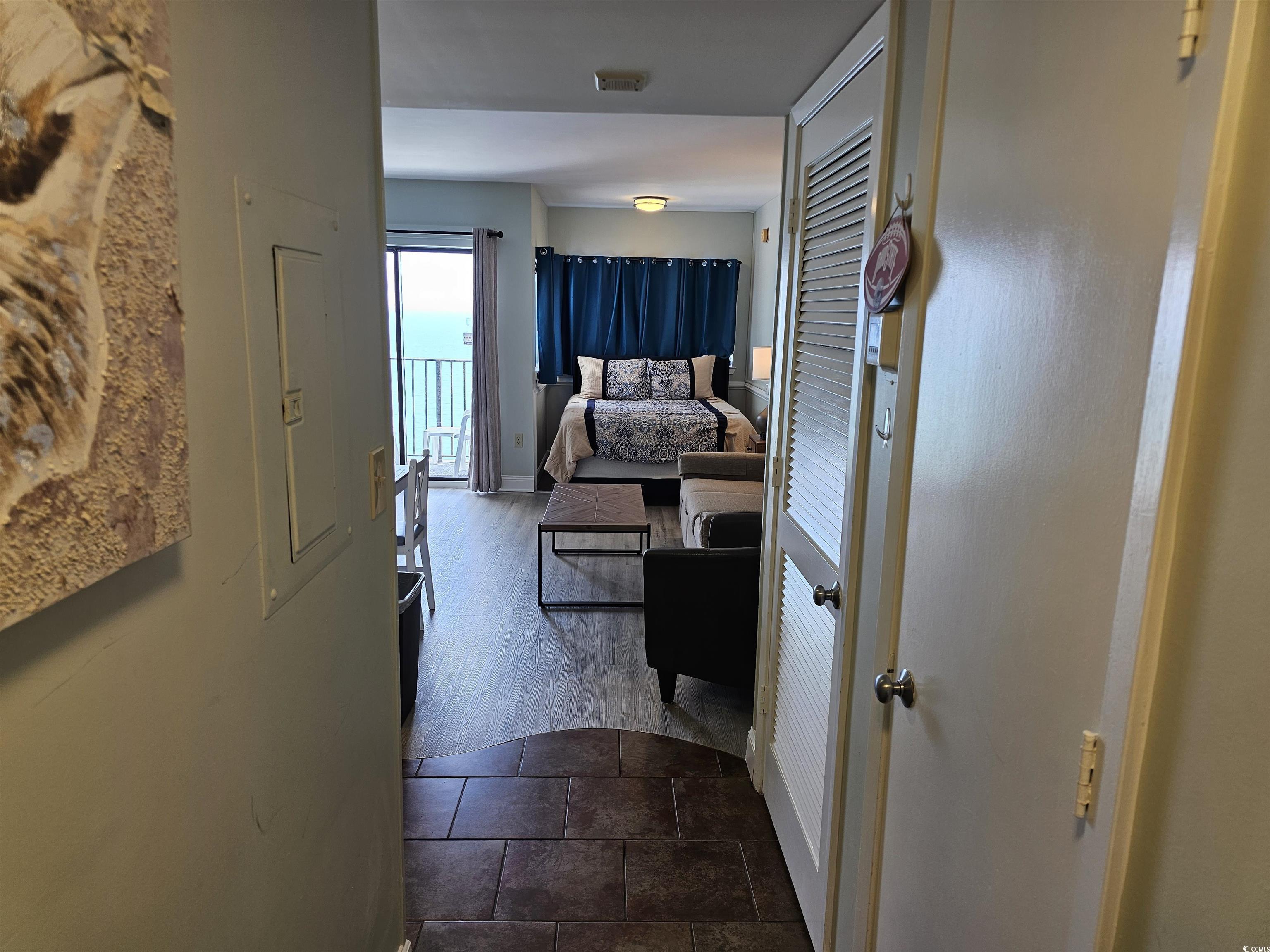 Image 2: Hallway with visible vents, baseboards, and dark w Image 2: Hallway with visible vents, baseboards, and dark w