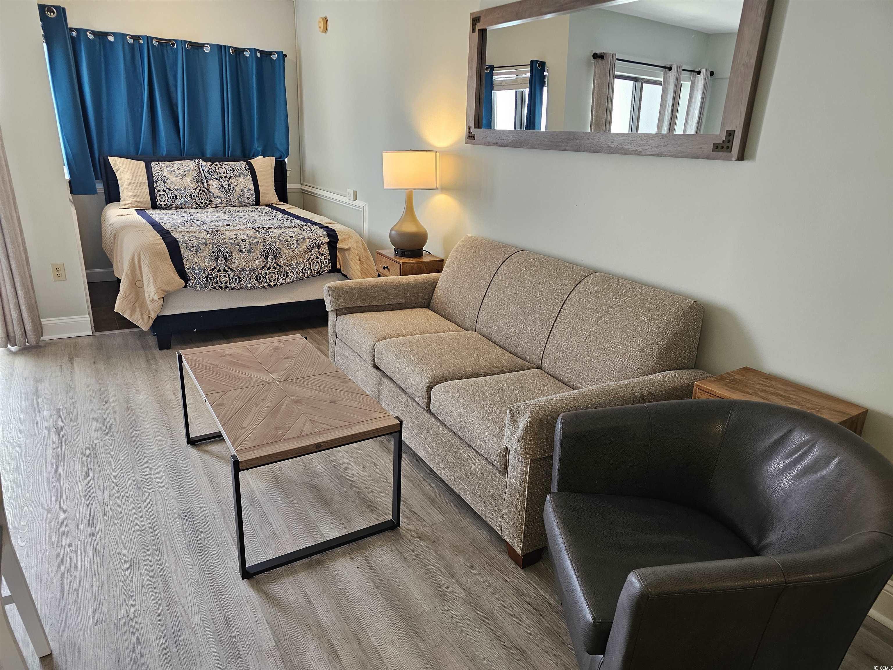 Image 4: Bedroom featuring baseboards and wood finished flo Image 4: Bedroom featuring baseboards and wood finished flo