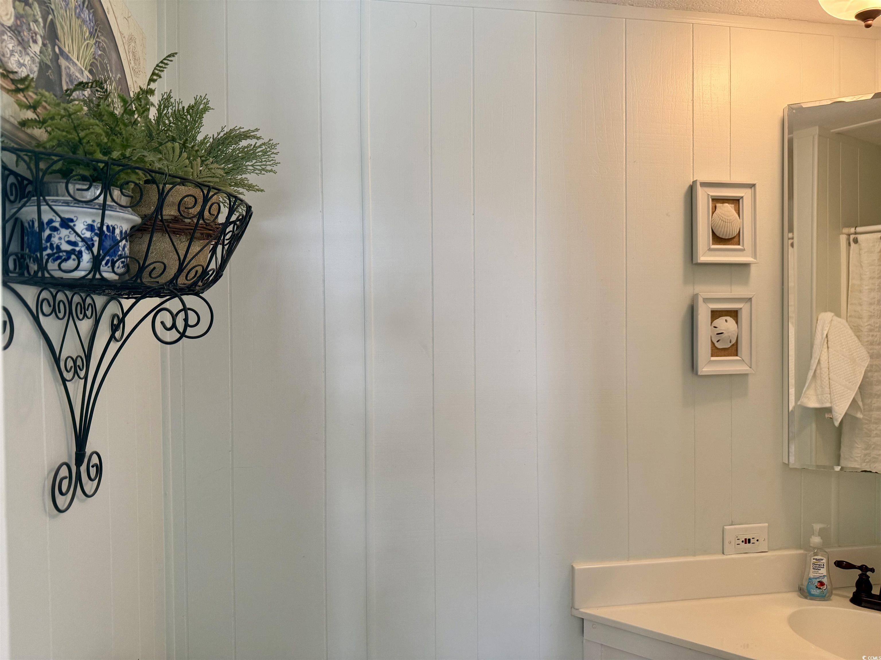 Image 4: Bathroom featuring vanity and a decorative wall Image 4: Bathroom featuring vanity and a decorative wall