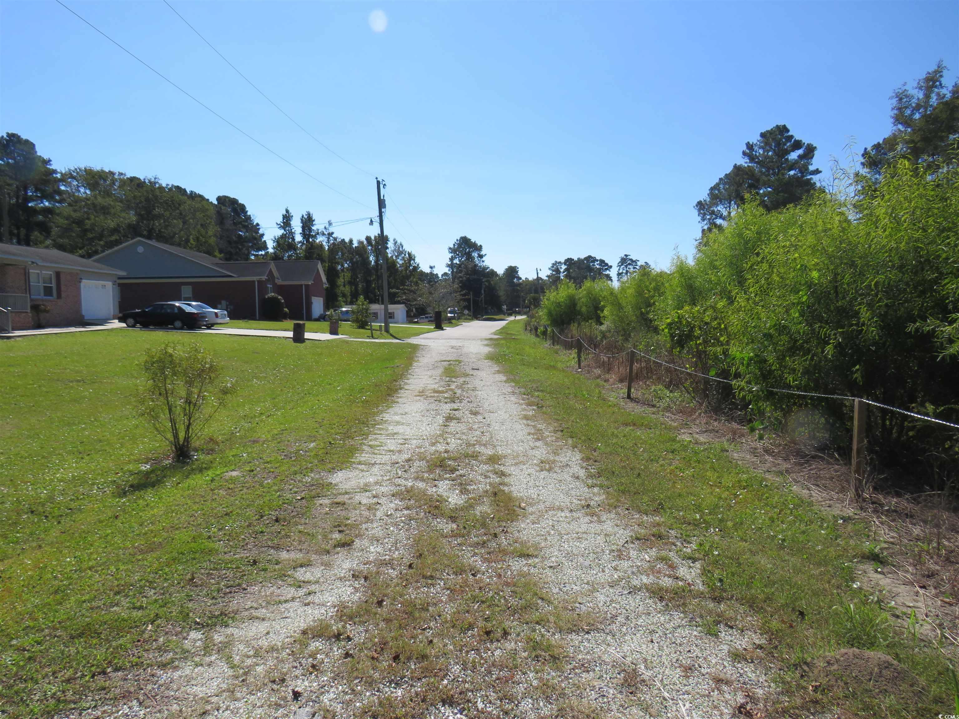 Image 3: View of dirt / gravel road with view of scattered Image 3: View of dirt / gravel road with view of scattered