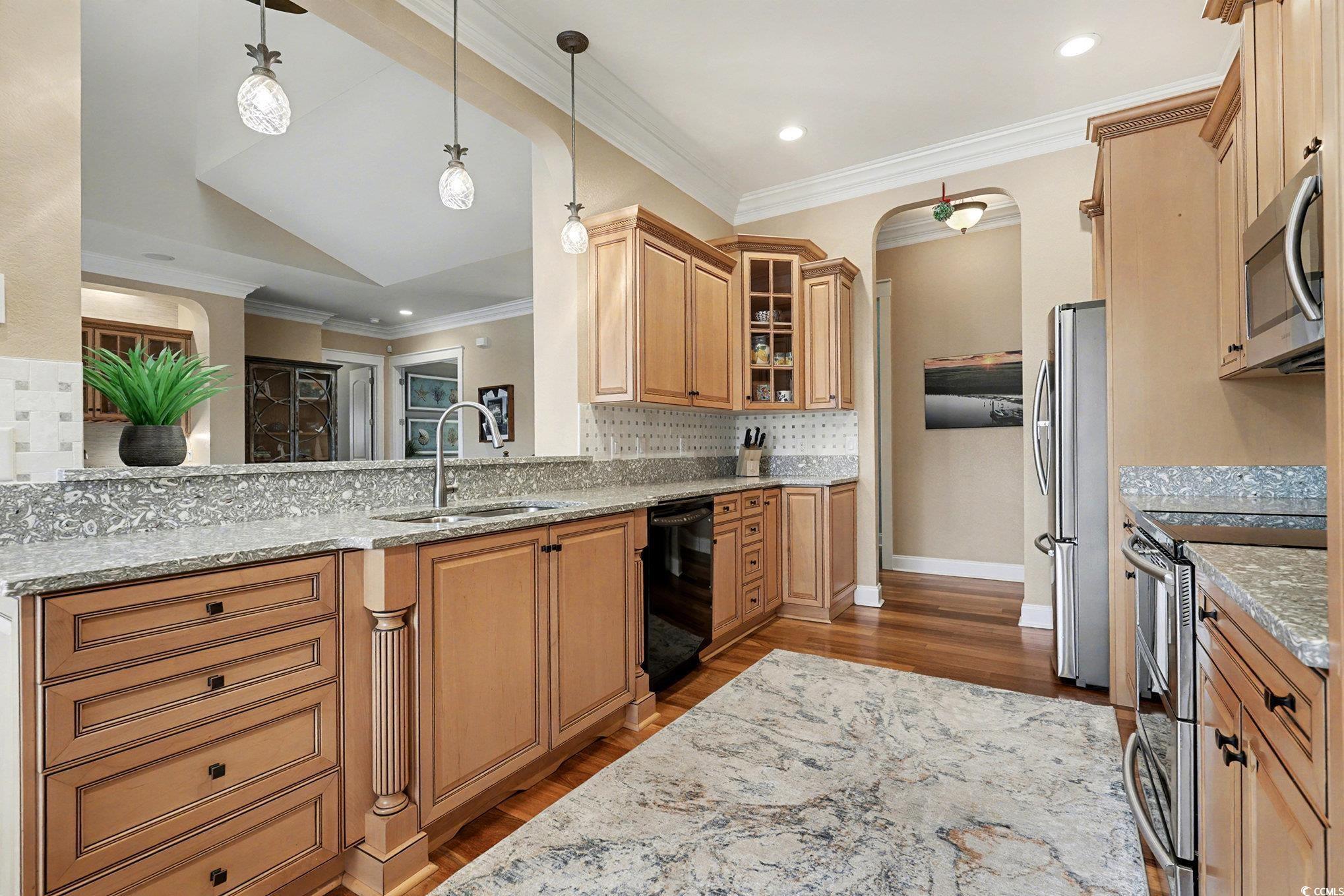 Image 3: Kitchen featuring light stone counters, appliances