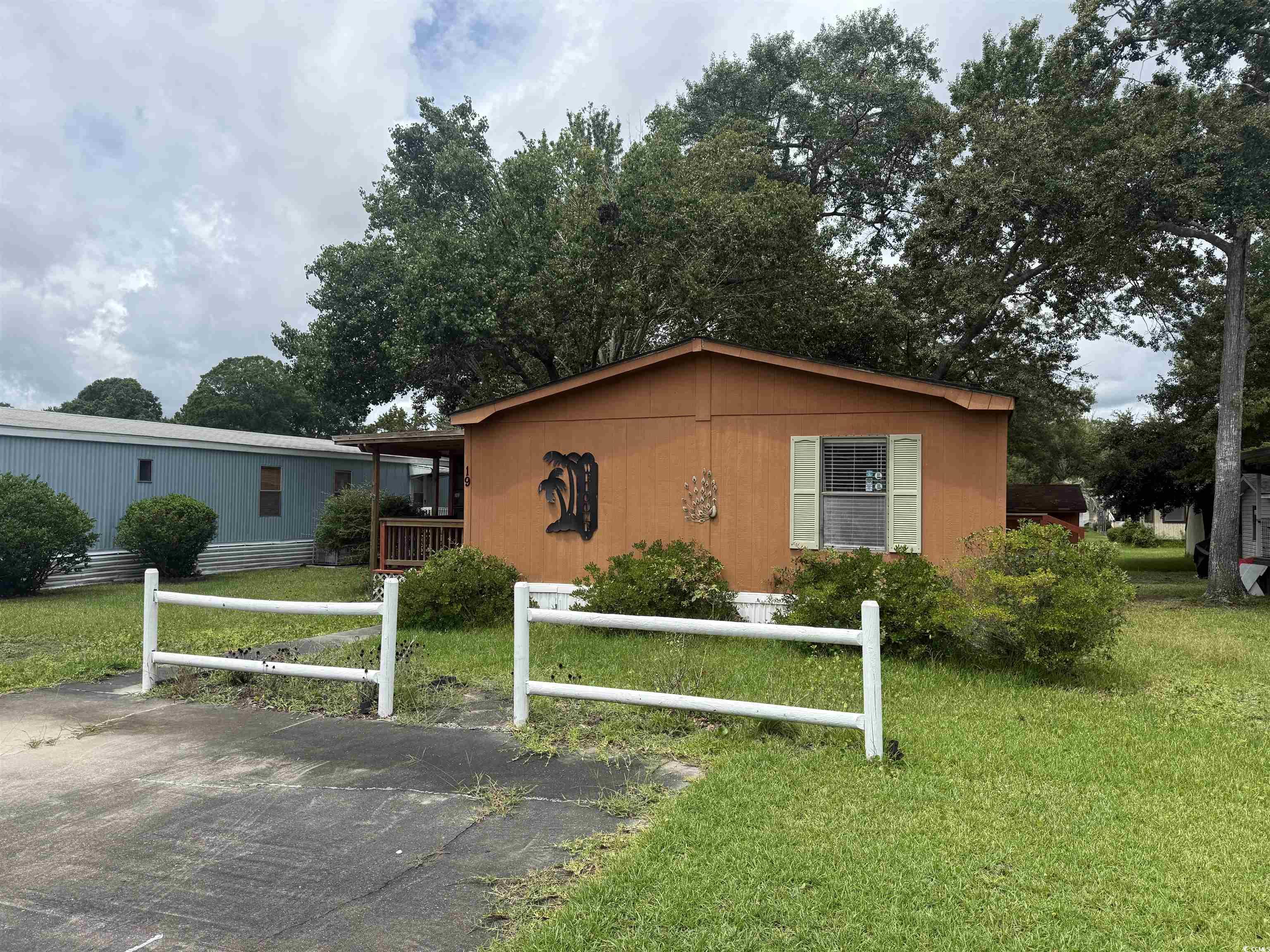 Image 1: View of property exterior with a yard