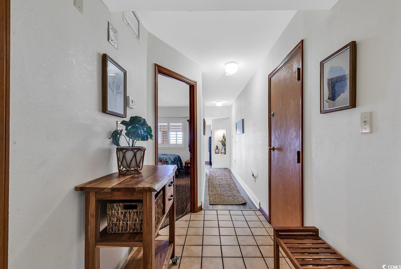Image 2: Corridor featuring light tile patterned floors