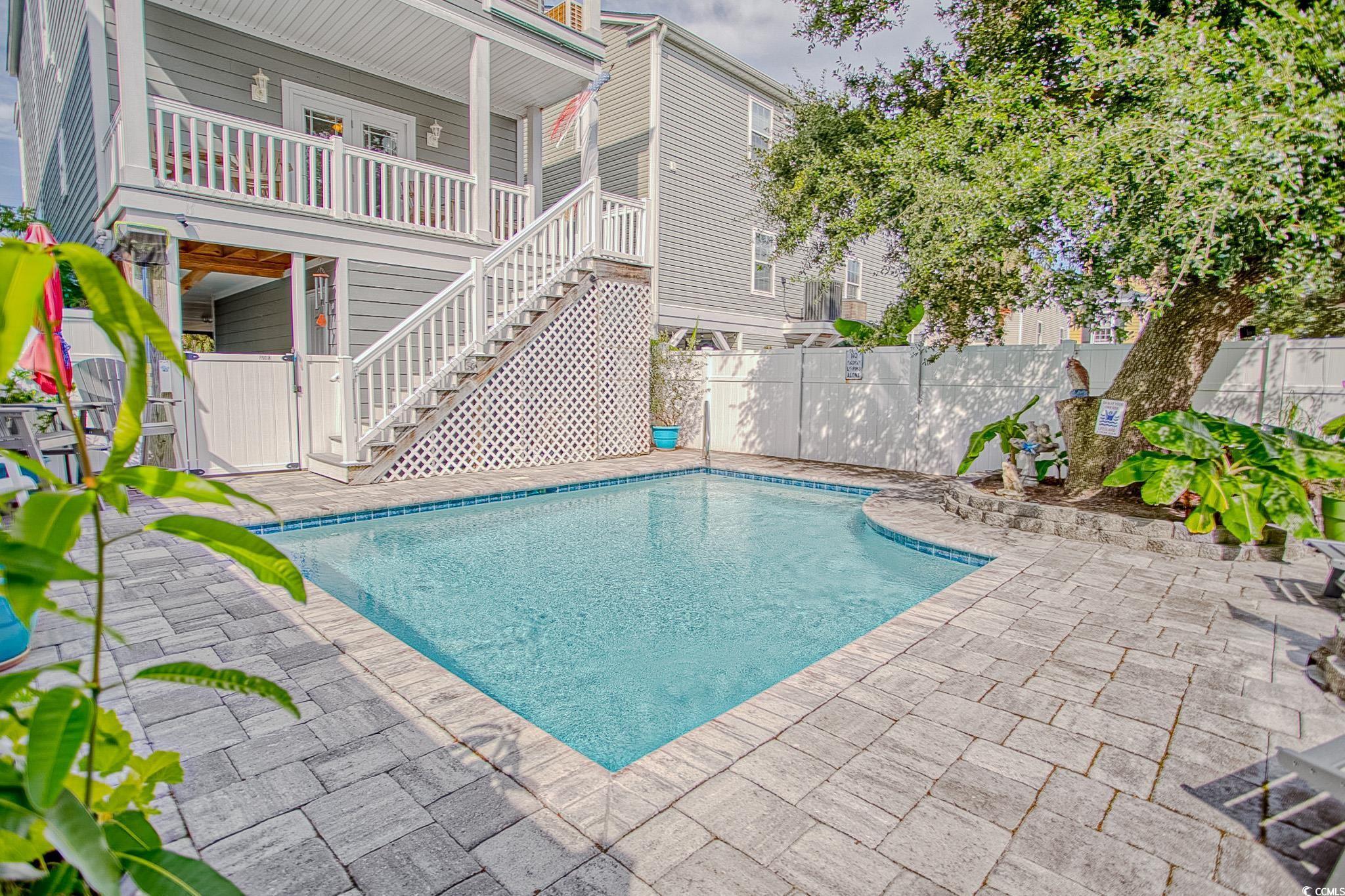 Image 4: View of pool featuring a fenced backyard, stairway