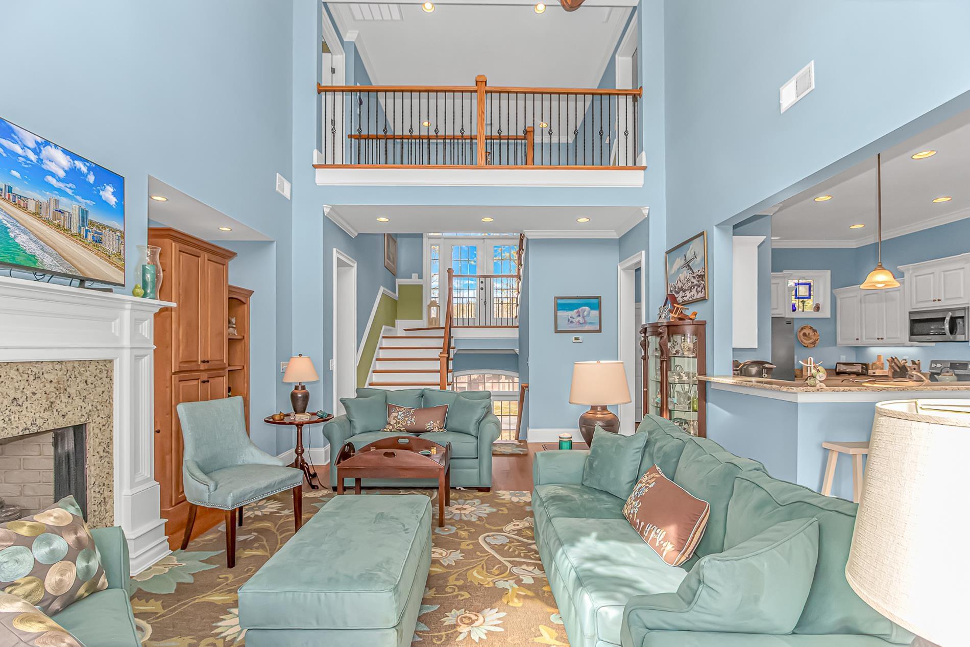 Image 4: Living room featuring wood finished floors, a towe