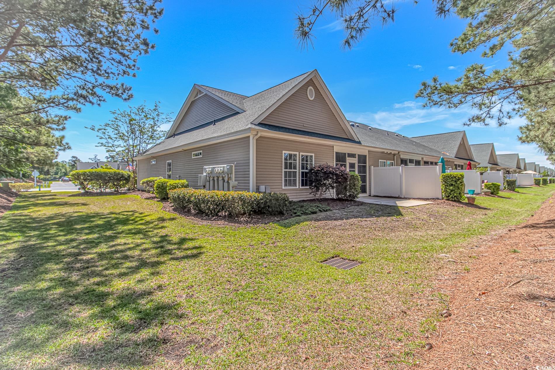 Image 2: View of side of property with a lawn, a shingled r Image 2: View of side of property with a lawn, a shingled r
