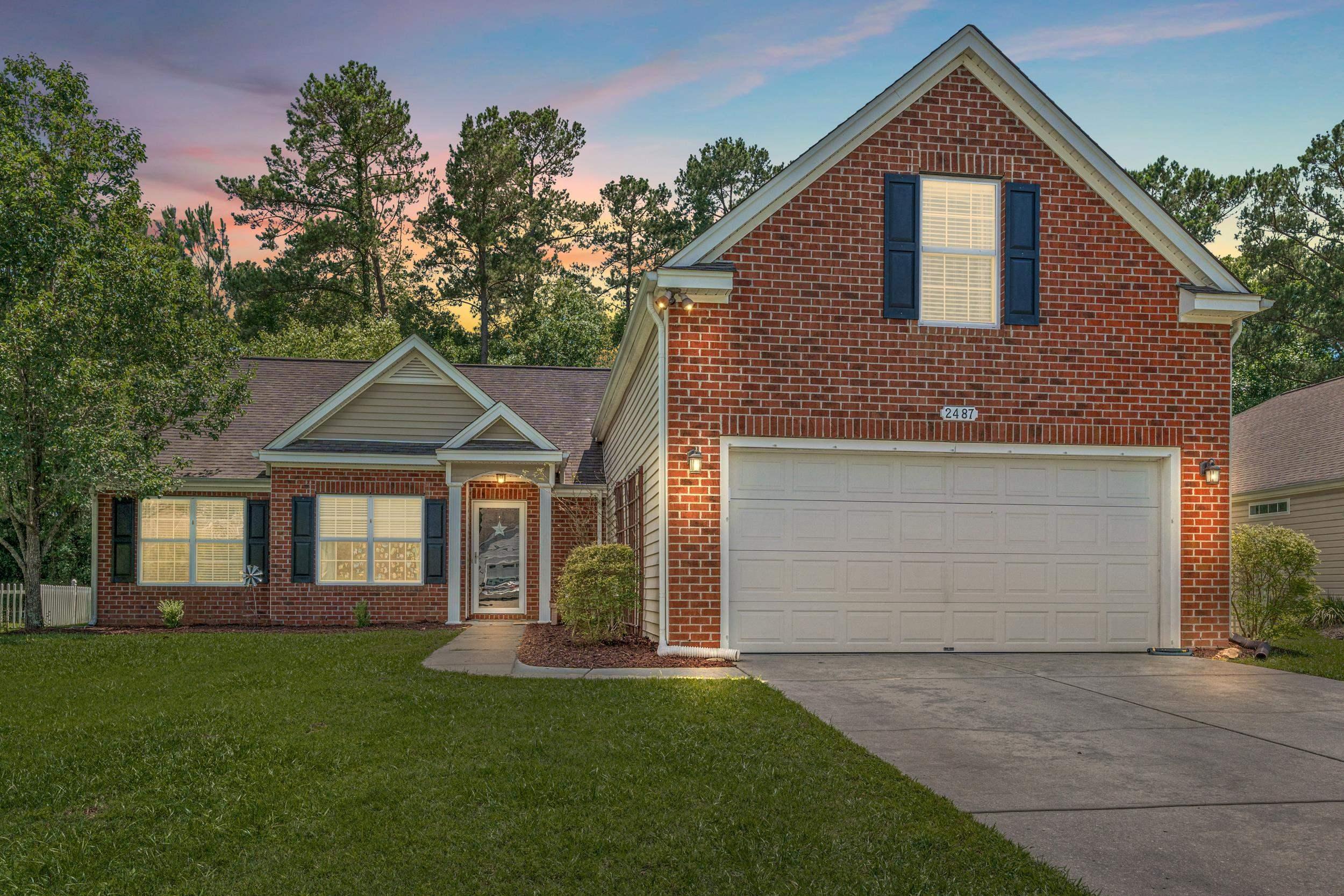 Image 1: View of front of home featuring brick siding, a ya Image 1: View of front of home featuring brick siding, a ya