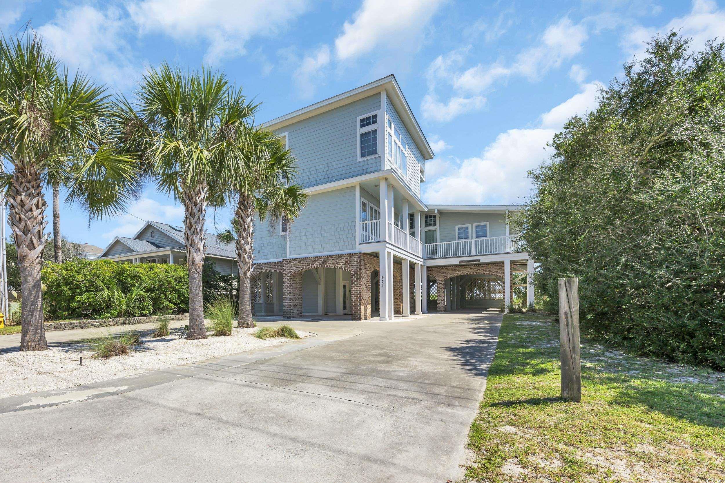 Image 2: Coastal inspired home featuring a carport and driv
