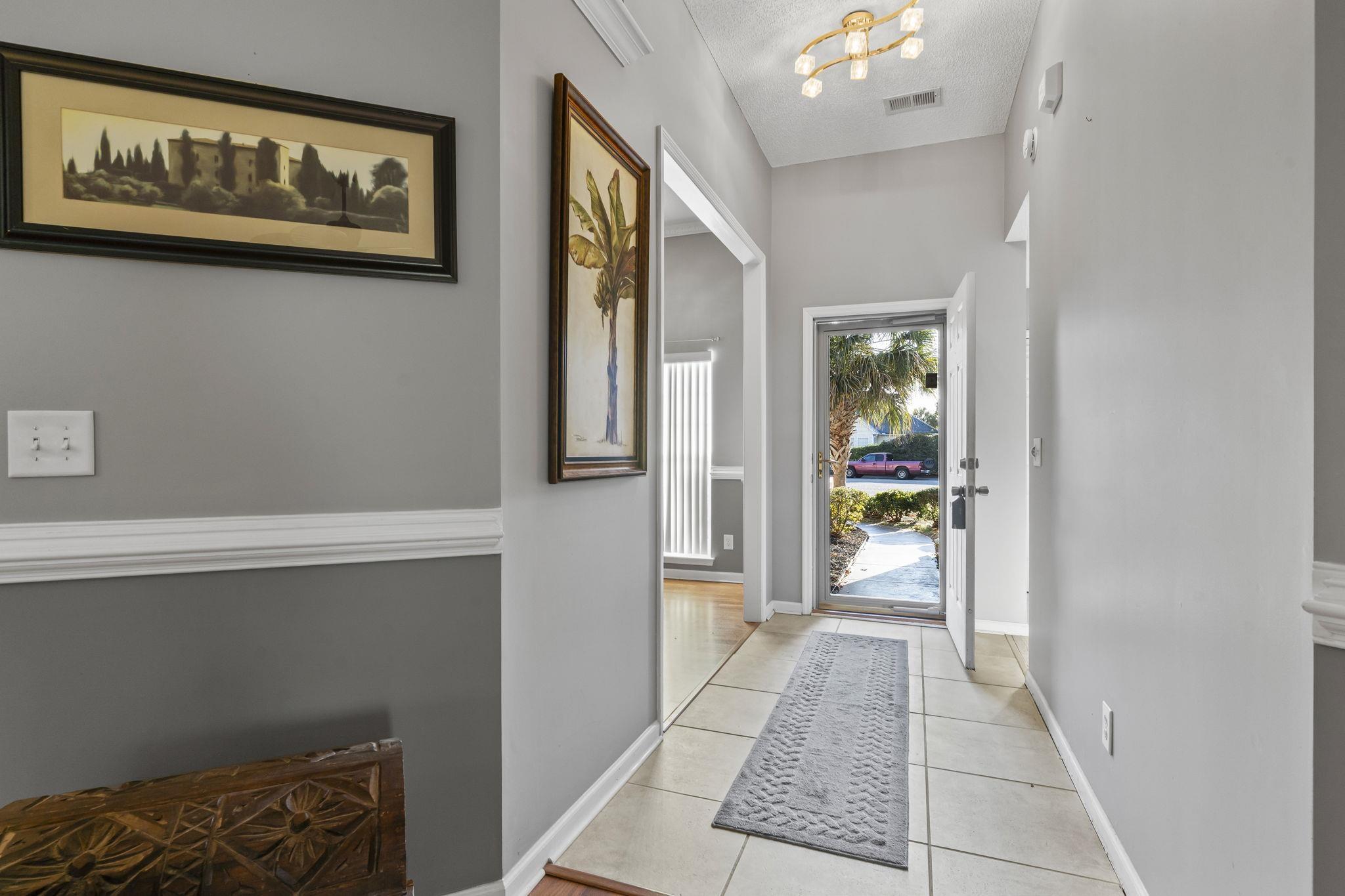 Image 2: Doorway to outside featuring tile patterned floors