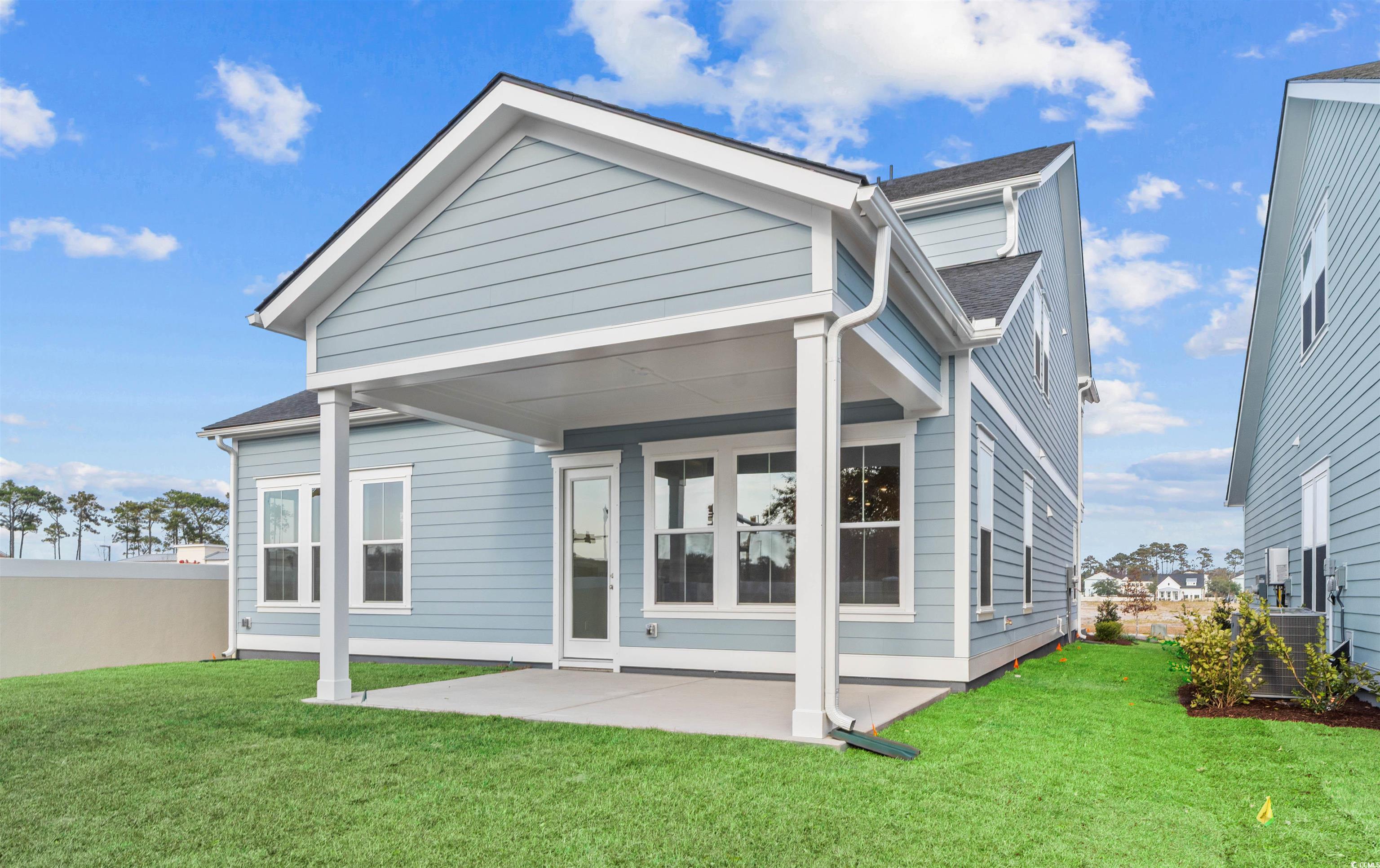 Image 3: Rear view of house with a patio and roof with shin Image 3: Rear view of house with a patio and roof with shin