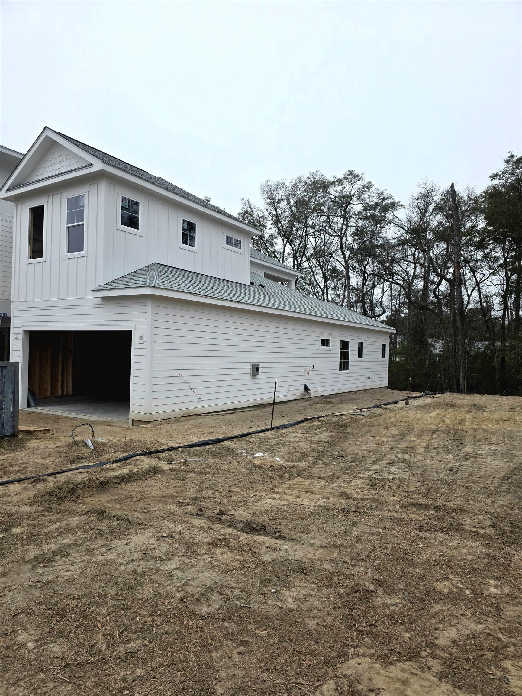 Image 2: View of home's exterior featuring board and batten