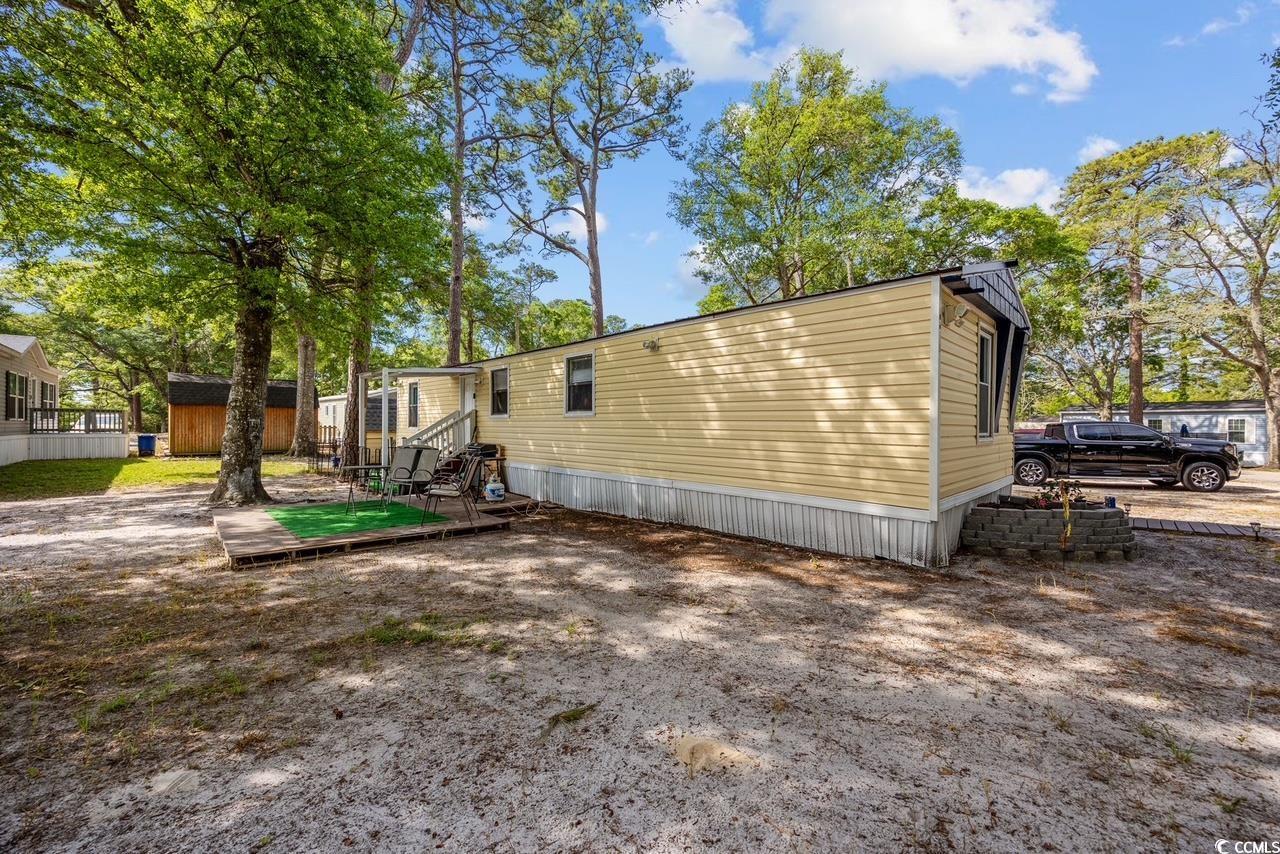 Image 2: Back of property with a storage shed and entry ste Image 2: Back of property with a storage shed and entry ste