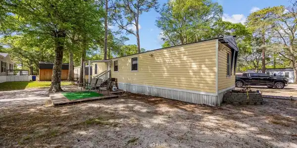 Image 2: Back of property with a storage shed and entry ste