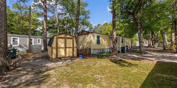 Image 3: View of side of property with a storage unit, a la